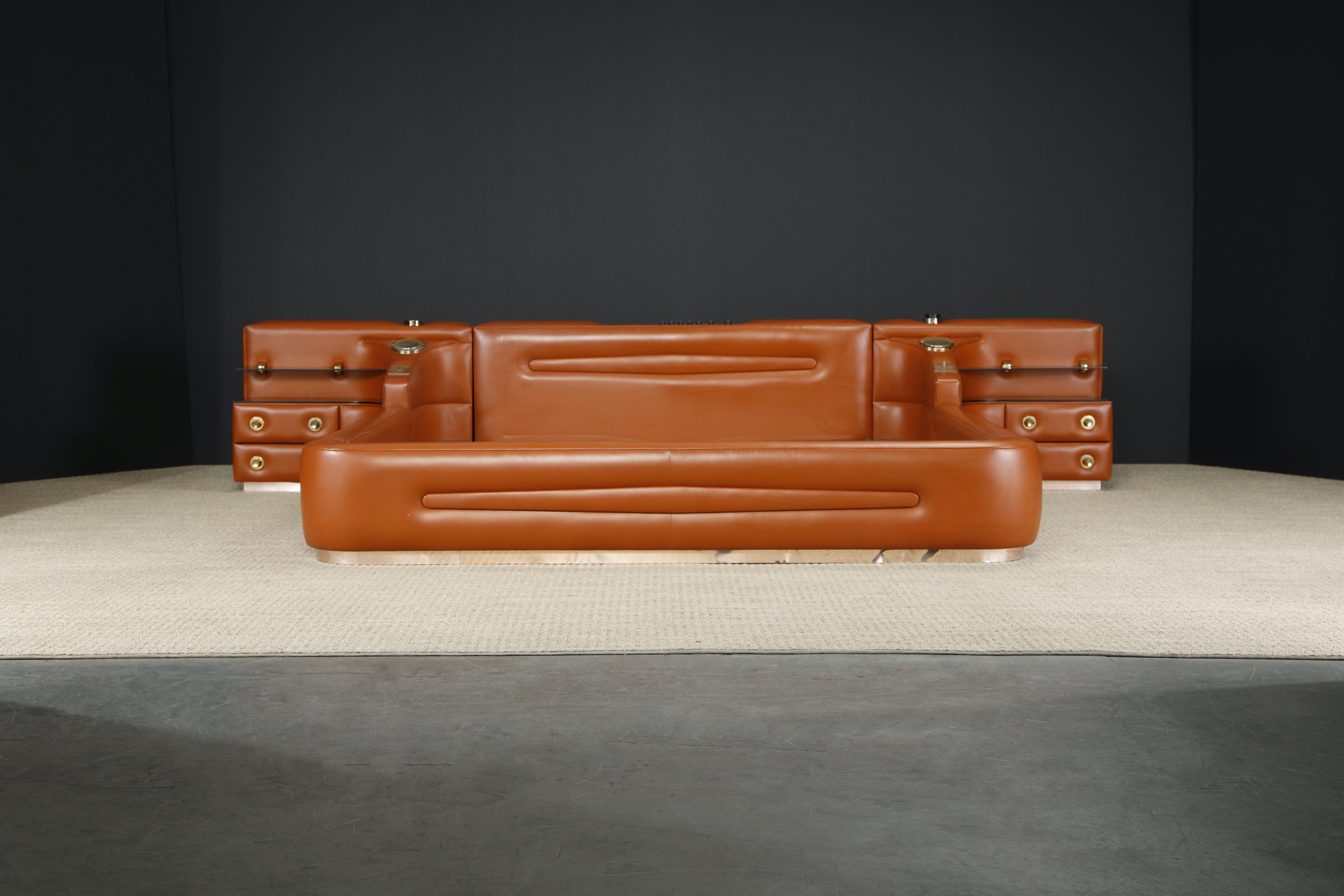 This unique and eye-catching custom integrated King-Sized leather bed is in the style of Guido Faleschini's Tucroma bed for i4 Mariani. Impressive amount of beautiful cognac color leather spanning across this monumental bed. 

This 1970s leather