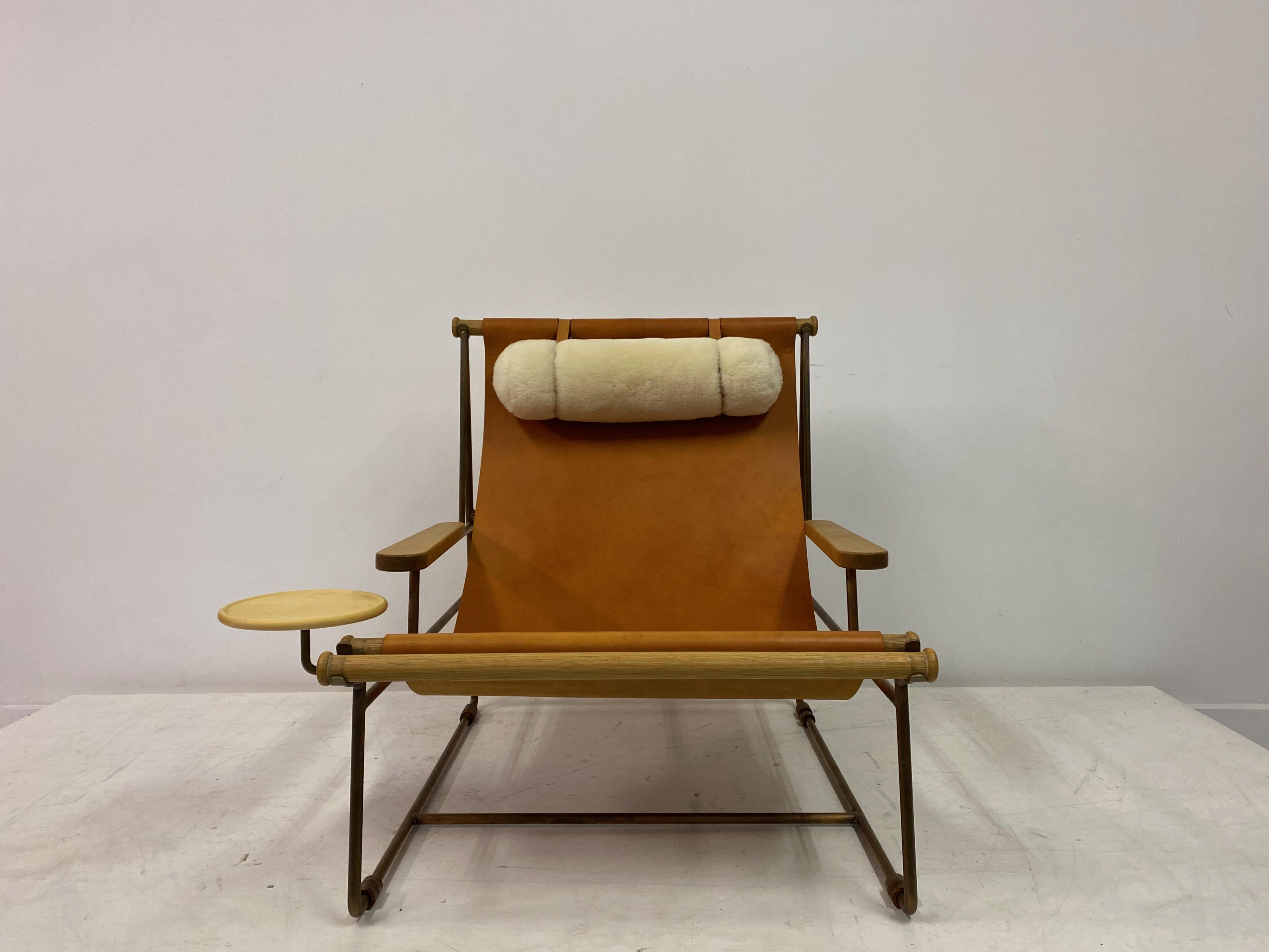 Leather lounge chair

Titled Deck chair

By Tyler Hays

For BDDW

Leather sling seat

Bronze frame

Shearling pillow

USA 21st century.