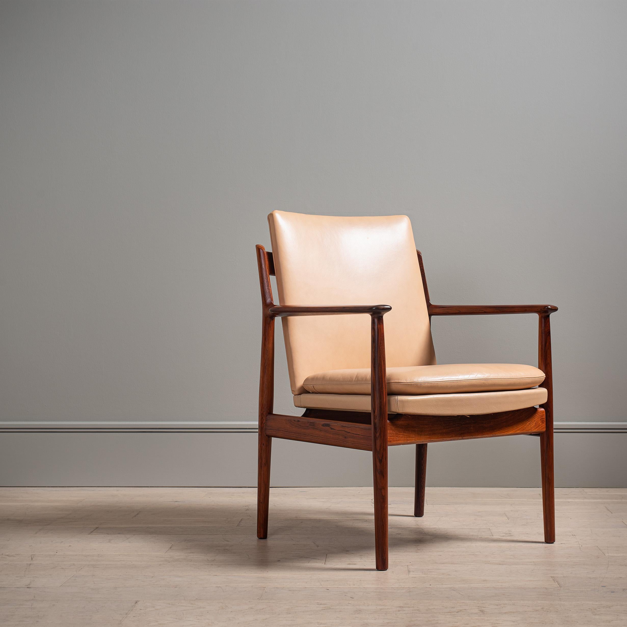 A wonderful Danish midcentury leather armchair or desk chair by Arne Vodder. Extremely nicely sculpted frame. A Classic design by Arne Vodder for the Sibast fine furniture company. Very high quality and comfortable chairs. 
Original maker labels