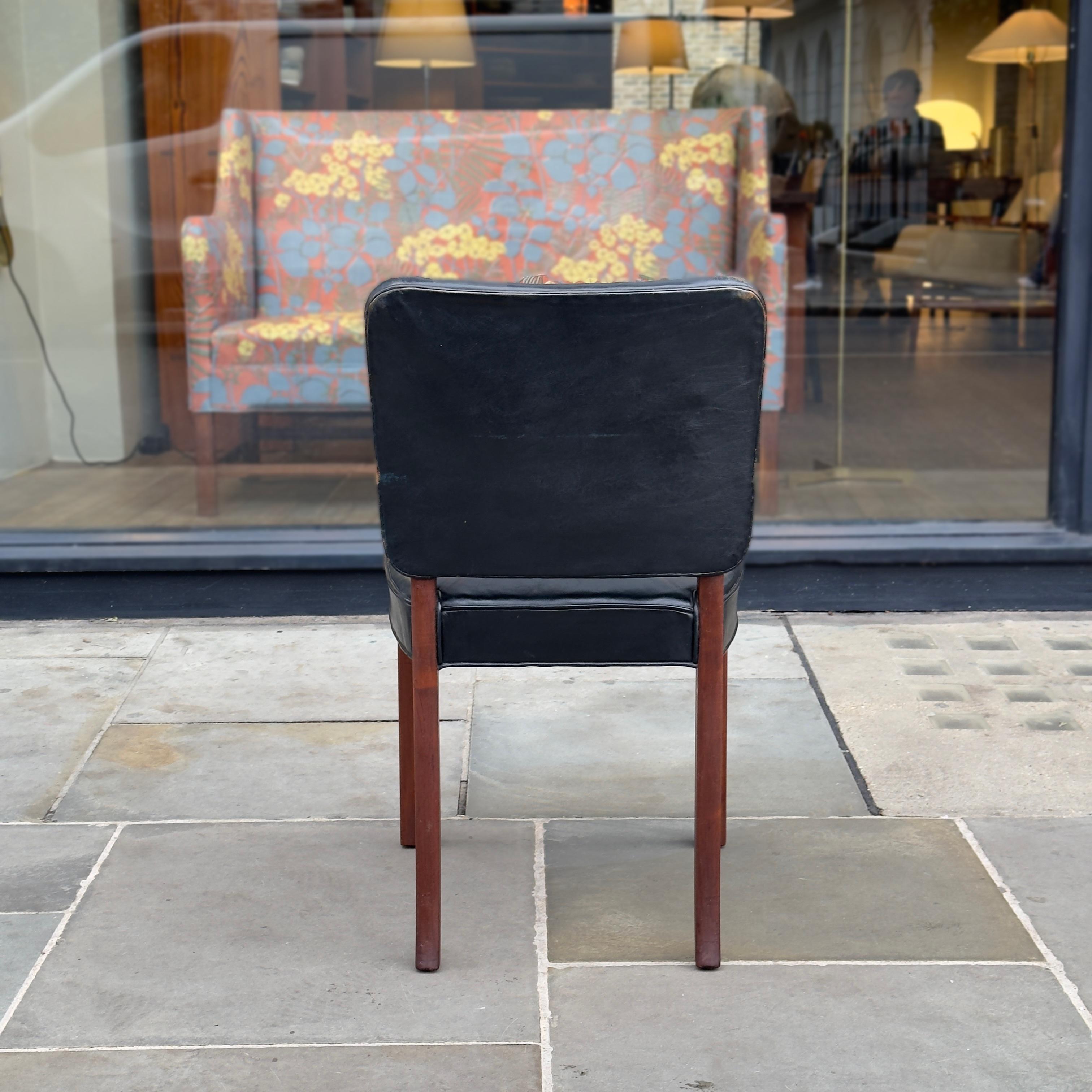 Description:
A black leather desk chair, produced by Normina, Denmark during the 1950s. With its spareness of line and neatly upholstered leather seat and back, this mahogany framed desk chair recalls the academic refinement of Kaare Klint’s 