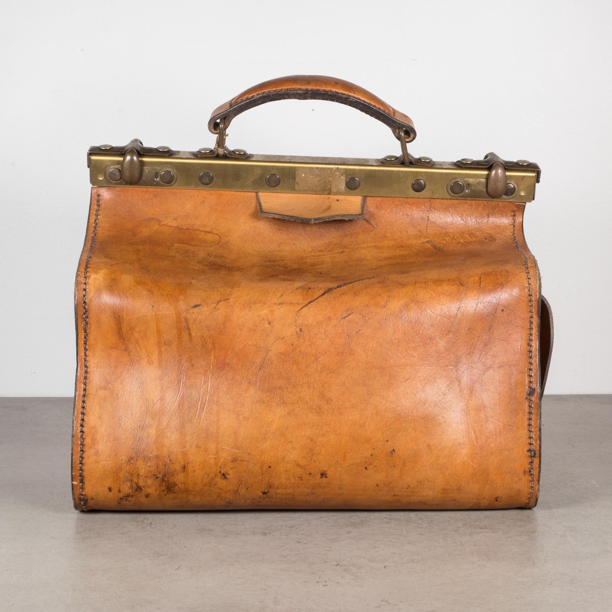 About

An original leather doctor's examination bag used to make house calls. The large interior is locked into place by brass brackets. The tobacco colored bag has one side pocket, brass and bronze locks, brass key, and a leather handle. Very