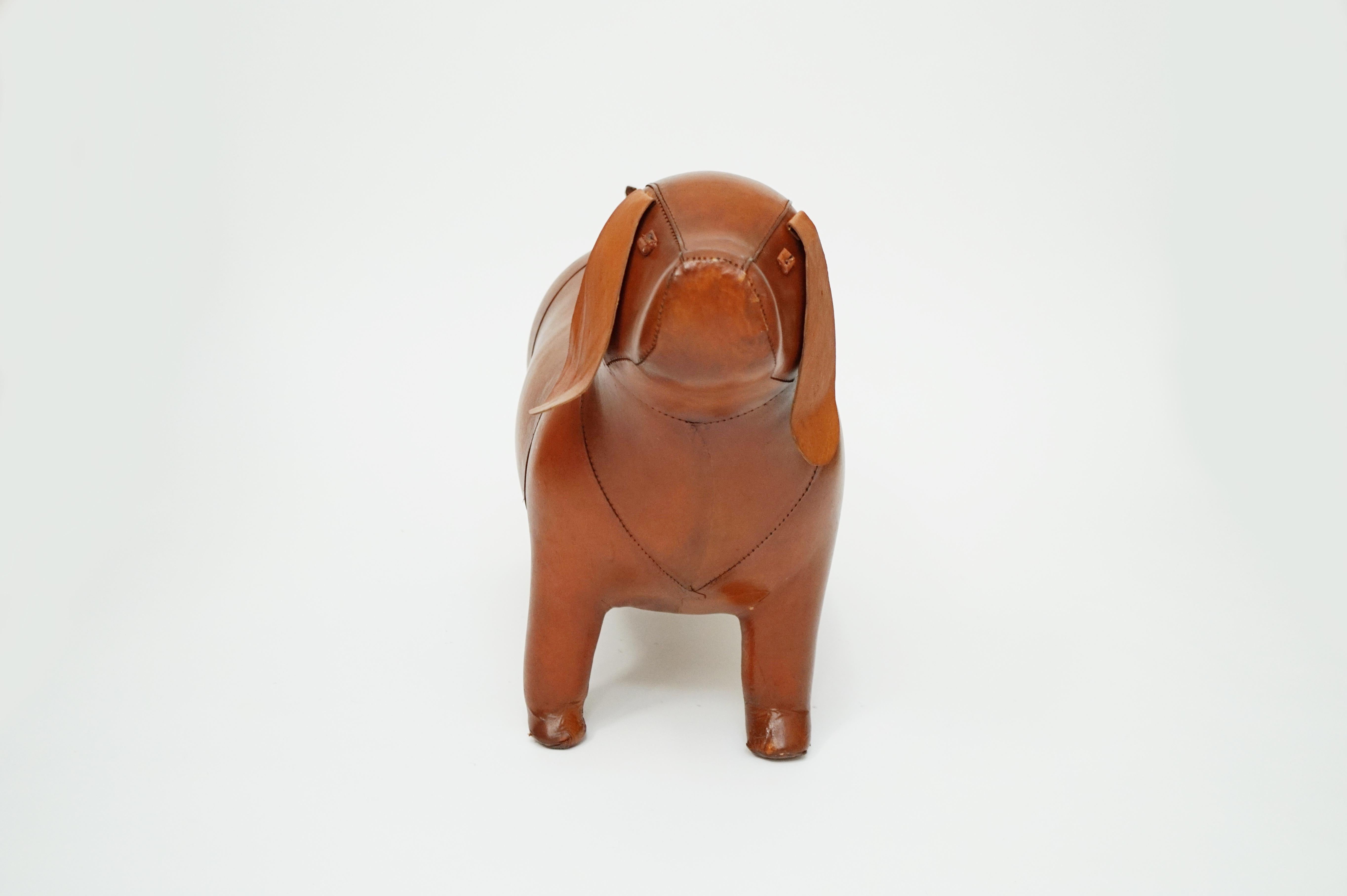 A wonderful leather Dog footstool attributed to Dimitri Omersa for Abercrombie and Fitch, circa 1970s. Sturdy and structurally sound, this dog is ready to be used as a footstool or use as a designer floor or tabletop sculpture or a friendly