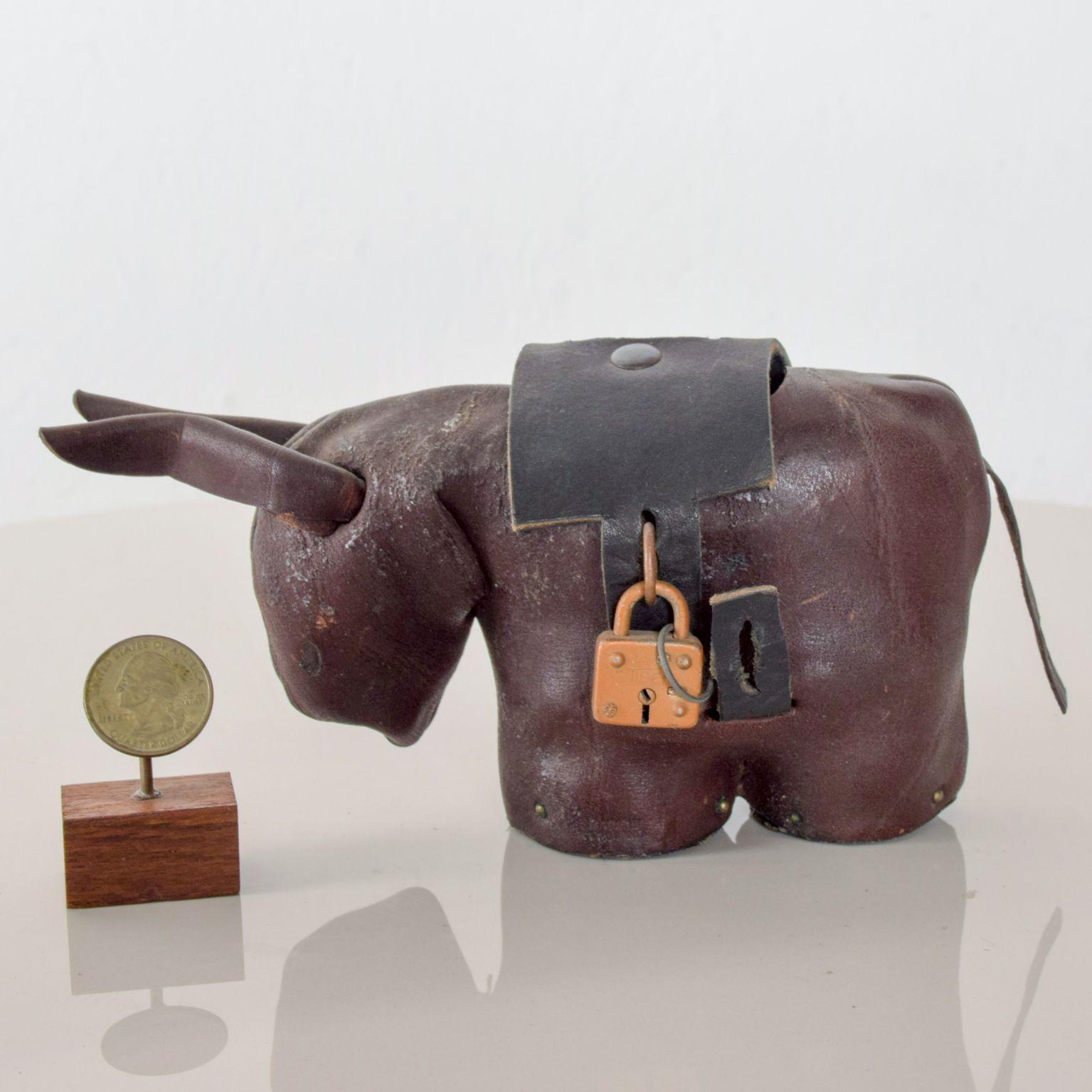 For your consideration: Vintage handcrafted leather donkey Mule Money coin bank attributed to Dimitri Omersa of Omersa and Co.

Stamped Made in England

Original key for the lock is not available.

Dimensions: 2 1/2