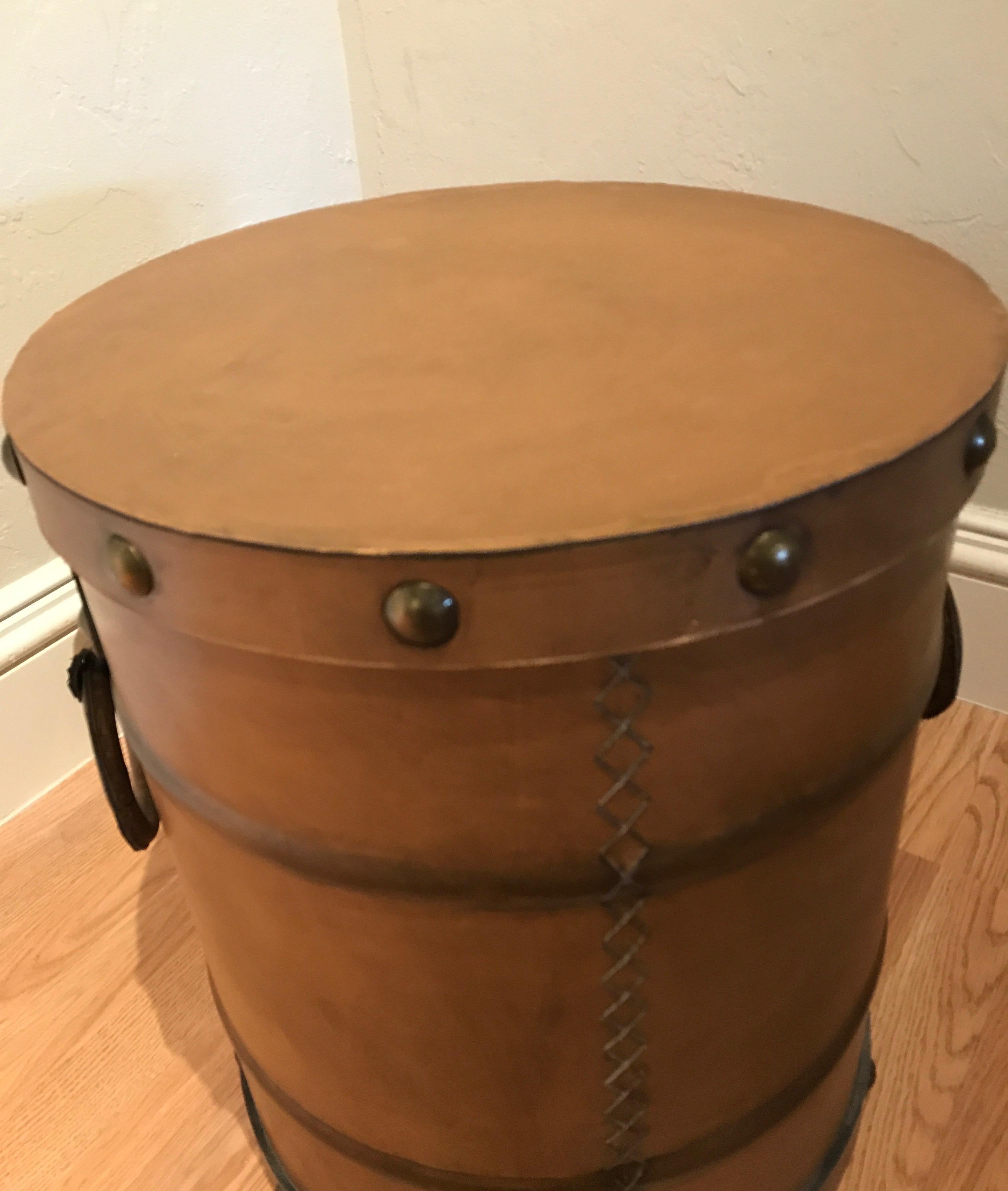 Leather drum table with two ring handles and removable top. Both top and bottom is studded.