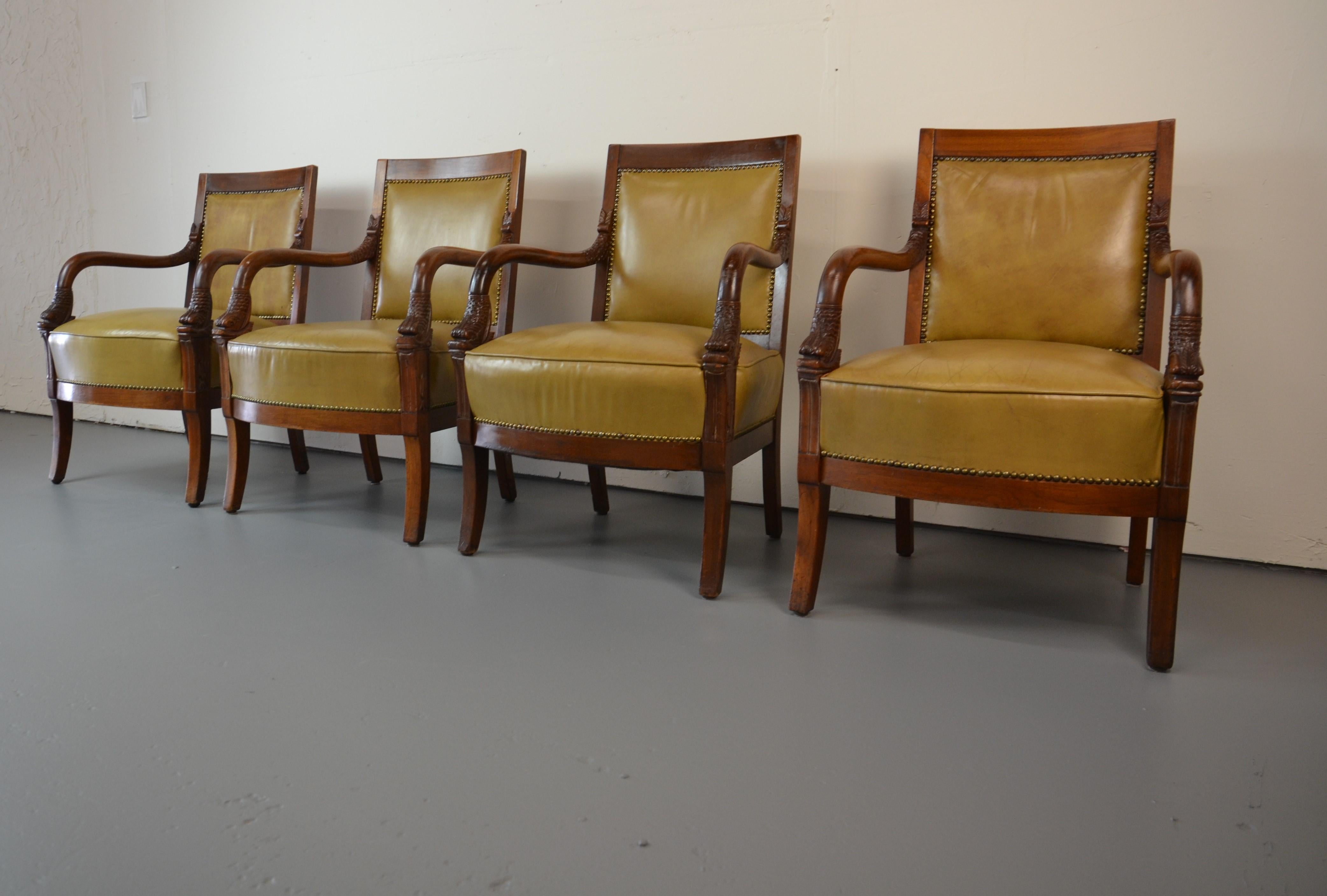 French Empire-style Napoleonic arm chairs. Carved Dolphin head arms. Leather upholstered. Demotion arm 26.50