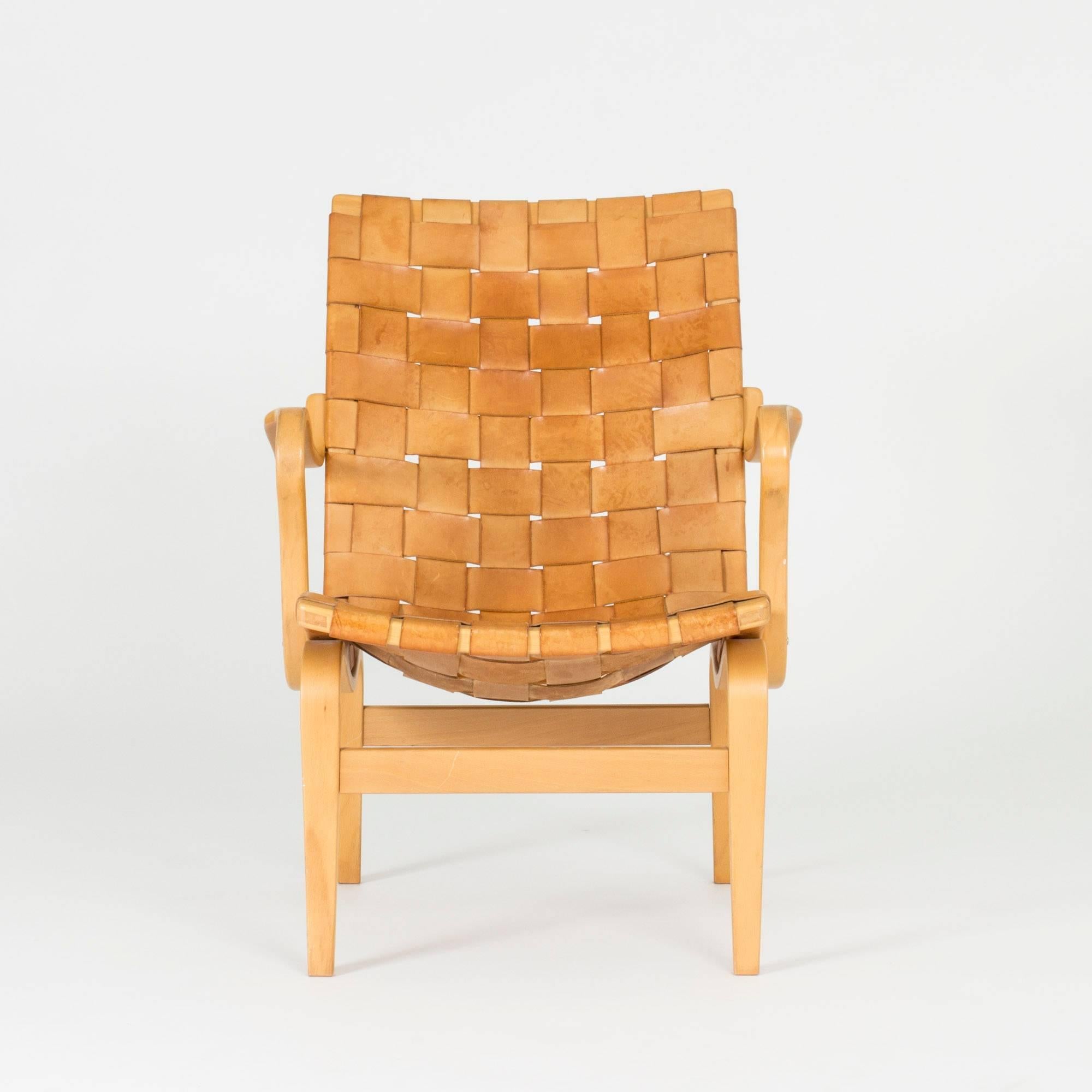 Gorgeous “Eva” lounge chair by Bruno Mathsson, with a wreathed leather seat on a beech bentwood frame. Beautifully patinated natural colored leather.