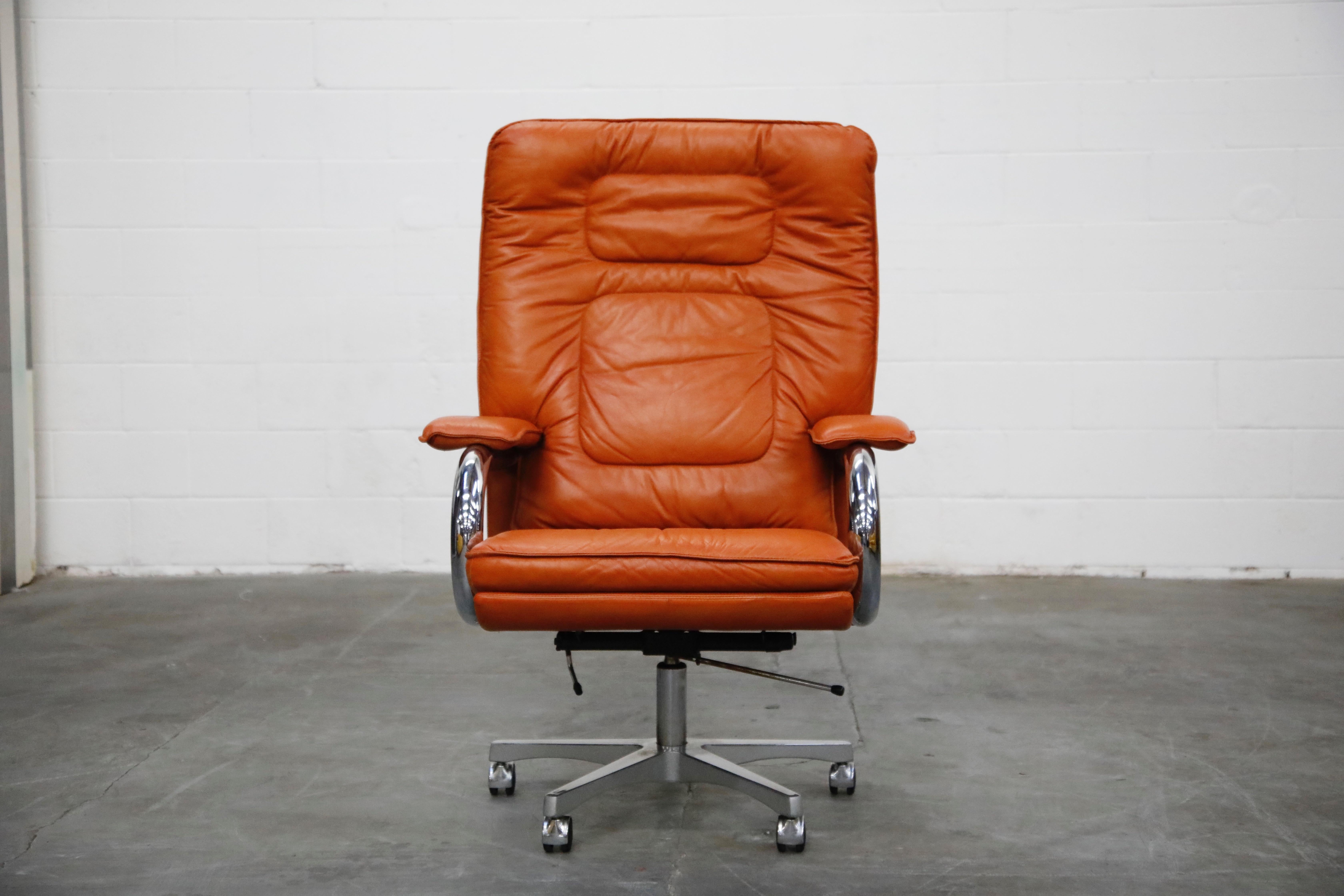 Elegant Guido Faleschini high back executive swivel desk chair by i4 Mariani for The Pace Collection. The seat and back retain the original high-quality and supple cognac / caramel color leather upholstery. The cushioned seat sits atop of a five