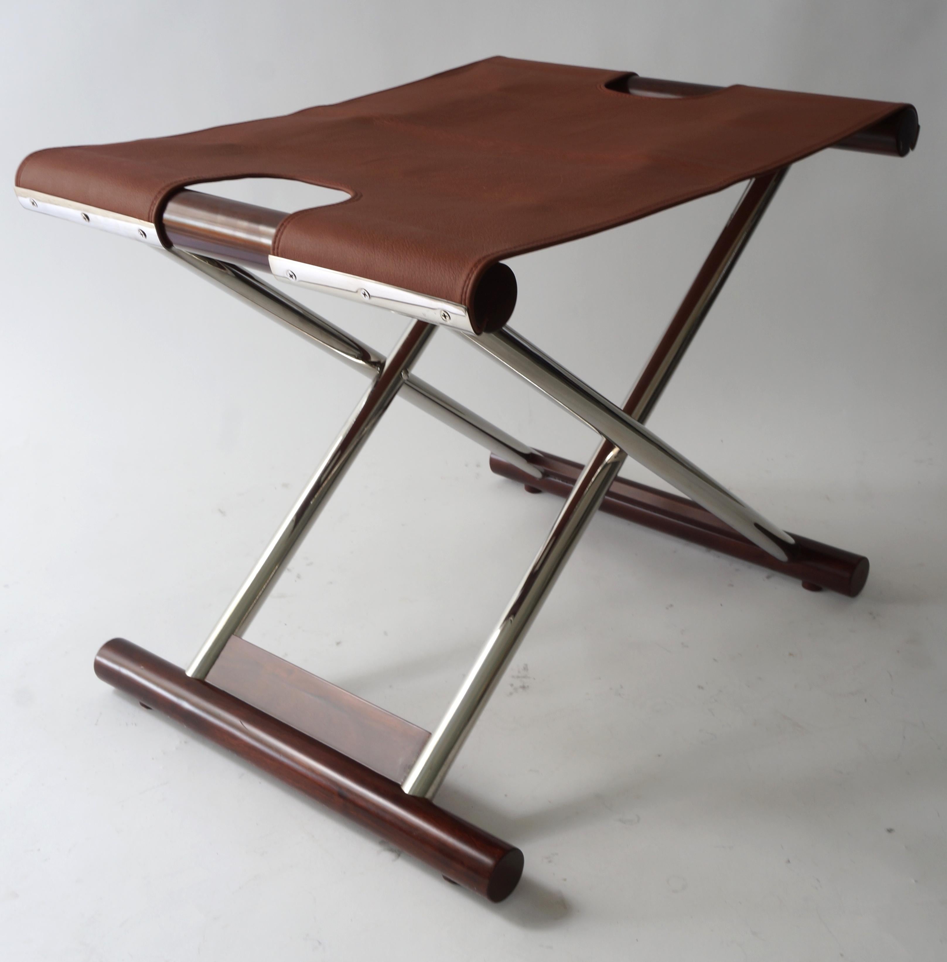 Vintage folding X-Sling stool in leather polished stainless steel and mahogany from a Palm Beach estate.

size when opened is 23 wide, 17.5 deep, and 19
