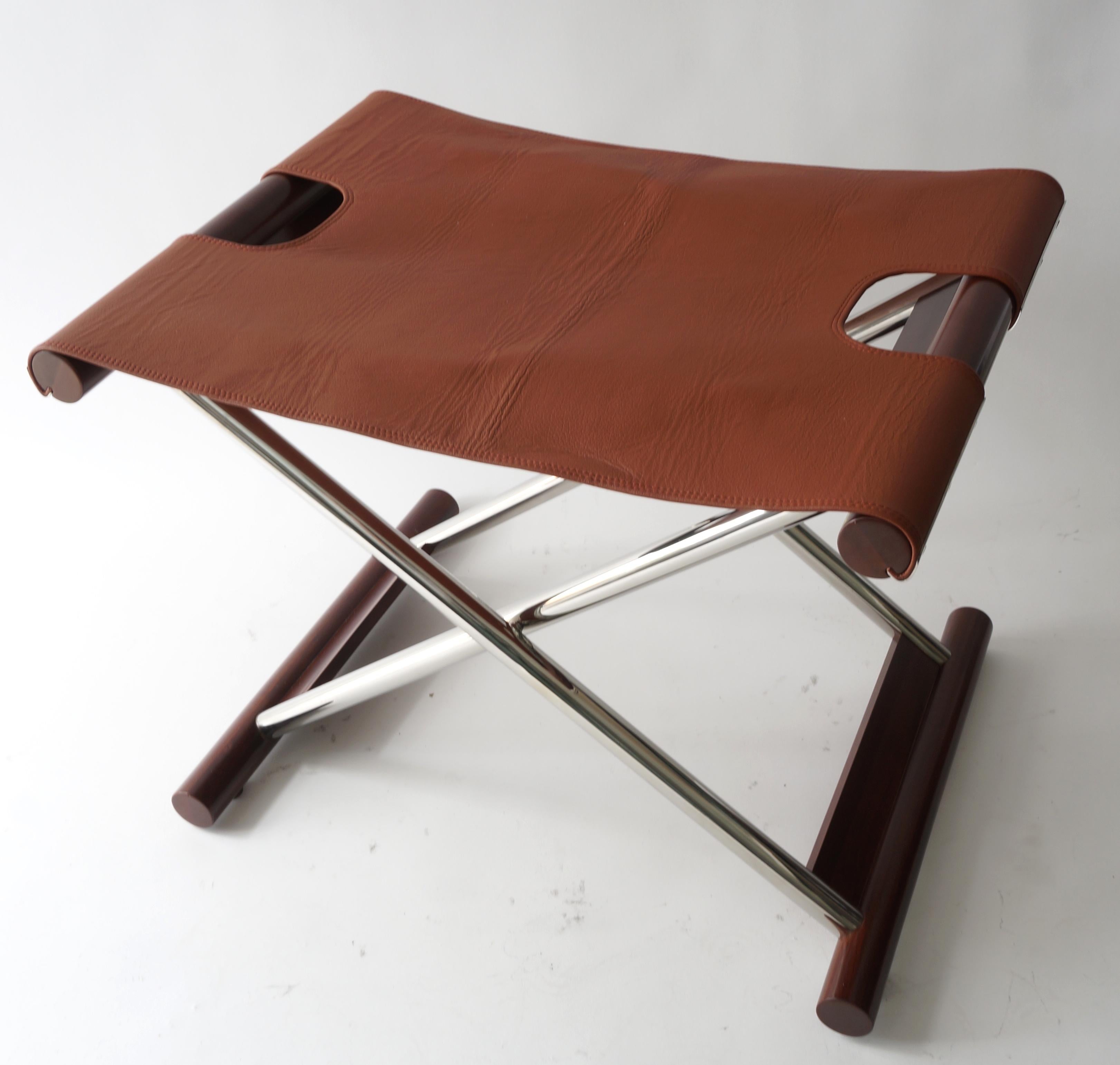 Vintage folding X-Sling stool in leather polished stainless steel and mahogany from a Palm Beach estate.

size when opened is 23 wide, 17.5 deep, and 19