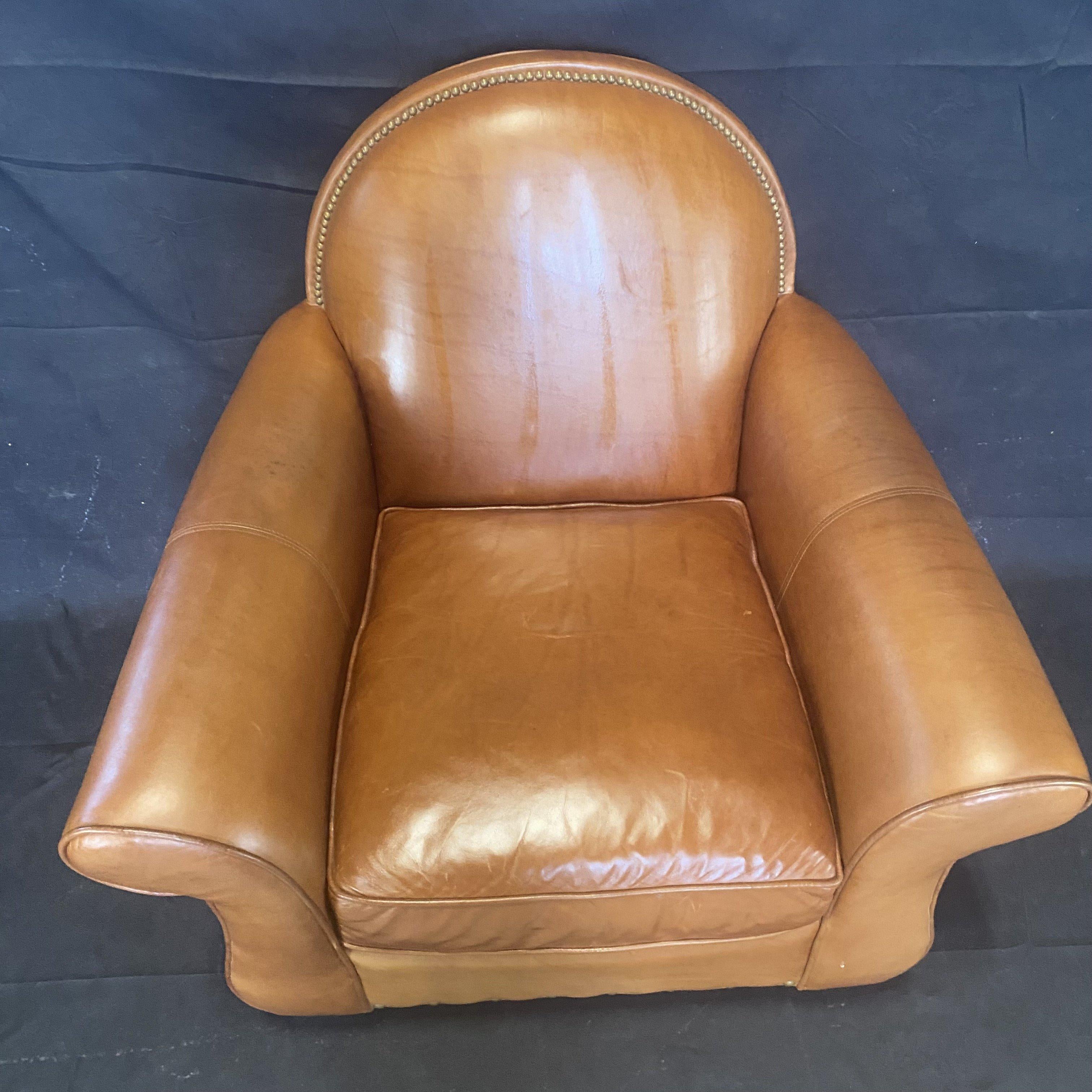 Classic comfy leather club chair with buttery soft brown leather accented with detailed nailhead trim along the round back. #5606