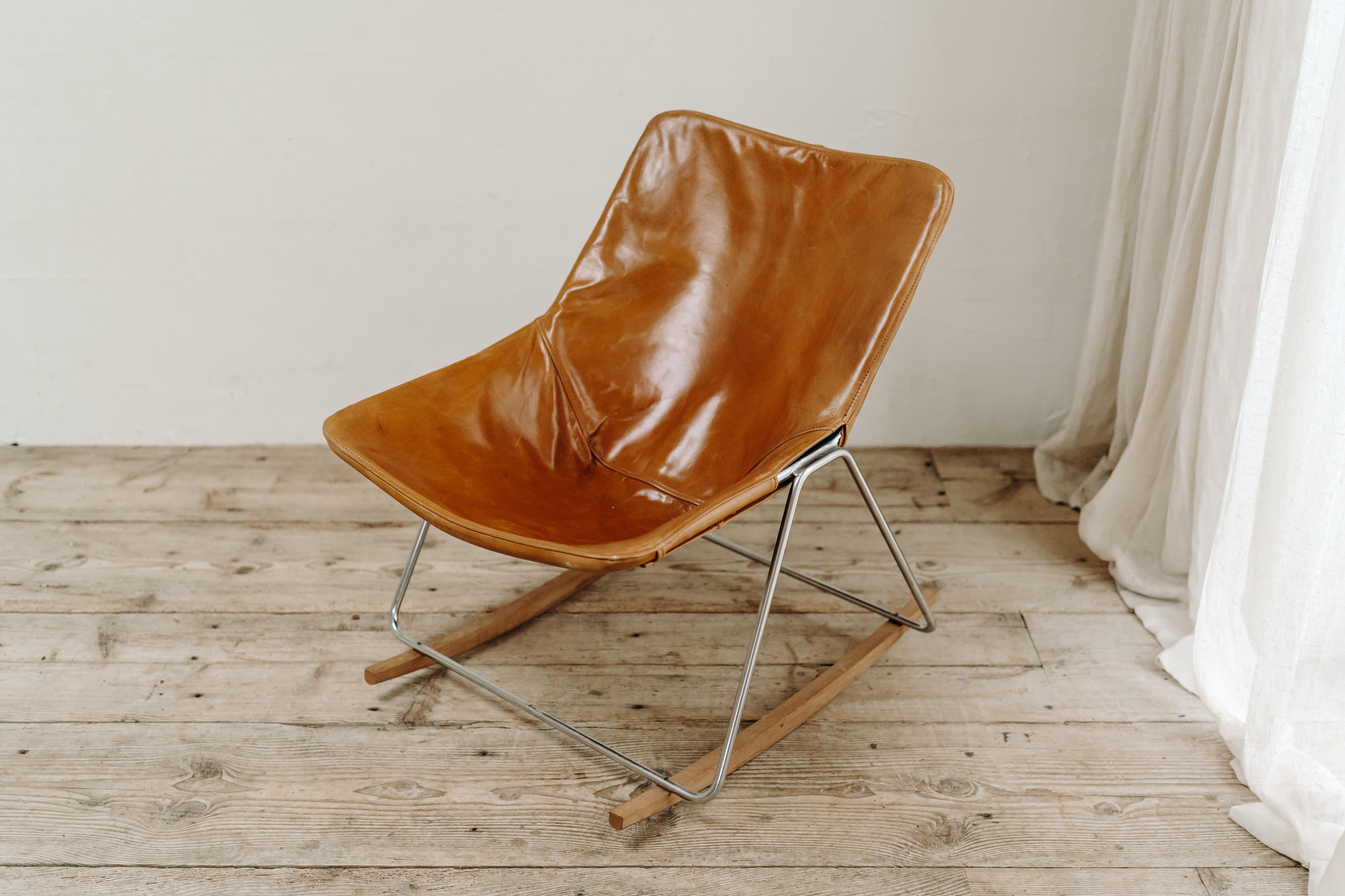 A rare G1 leather rocking chair by Pierre Guariche from Farnce, designed in the 1950's for Airborne. The simplistic and modern design consist of a tubular steel frame with a seating of congnac leather. Underneath two wooden feet to make this a