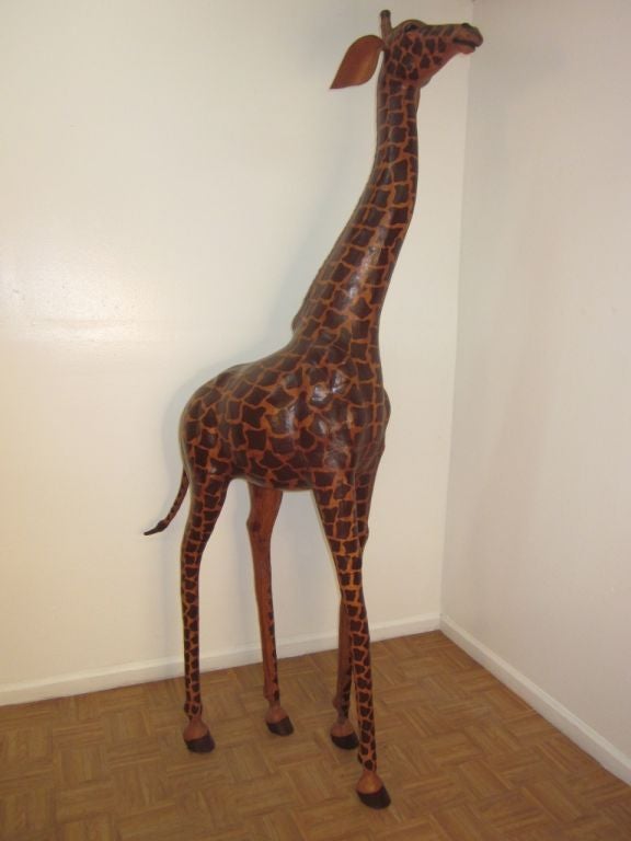 Very colorful tall giraffe. Would make a wonderful addition to a safari themed interior. Measures: 6ft. 8in.
