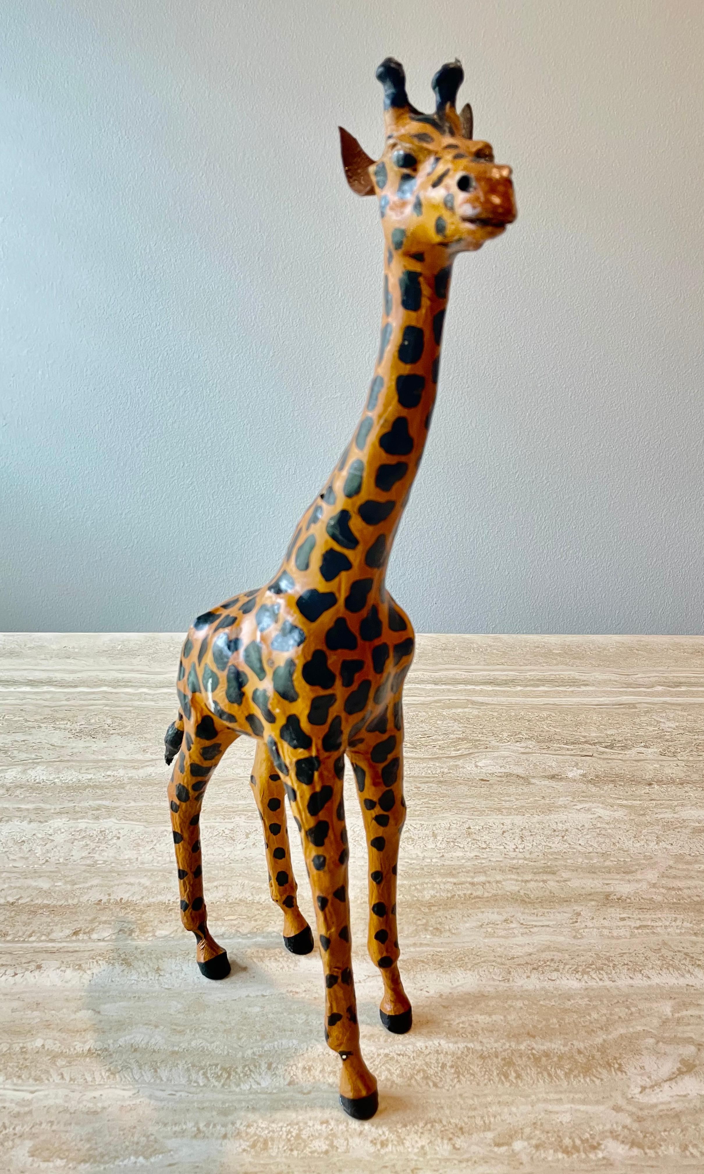 Beautiful sculpted leather giraffe sculpture. Great decorative addition for a bookshelf.