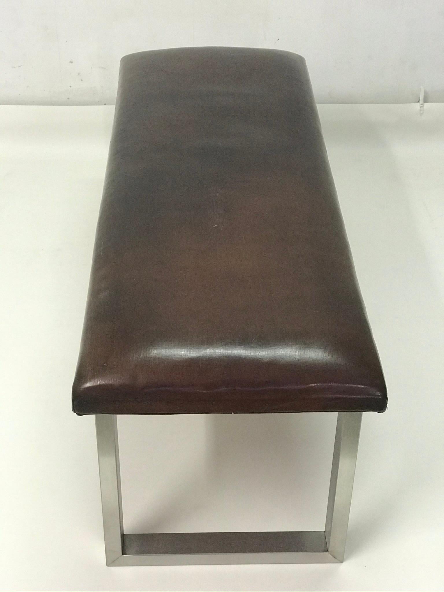 The bench has strong leather completed the stainless steel construction. The leather is in the original patina.