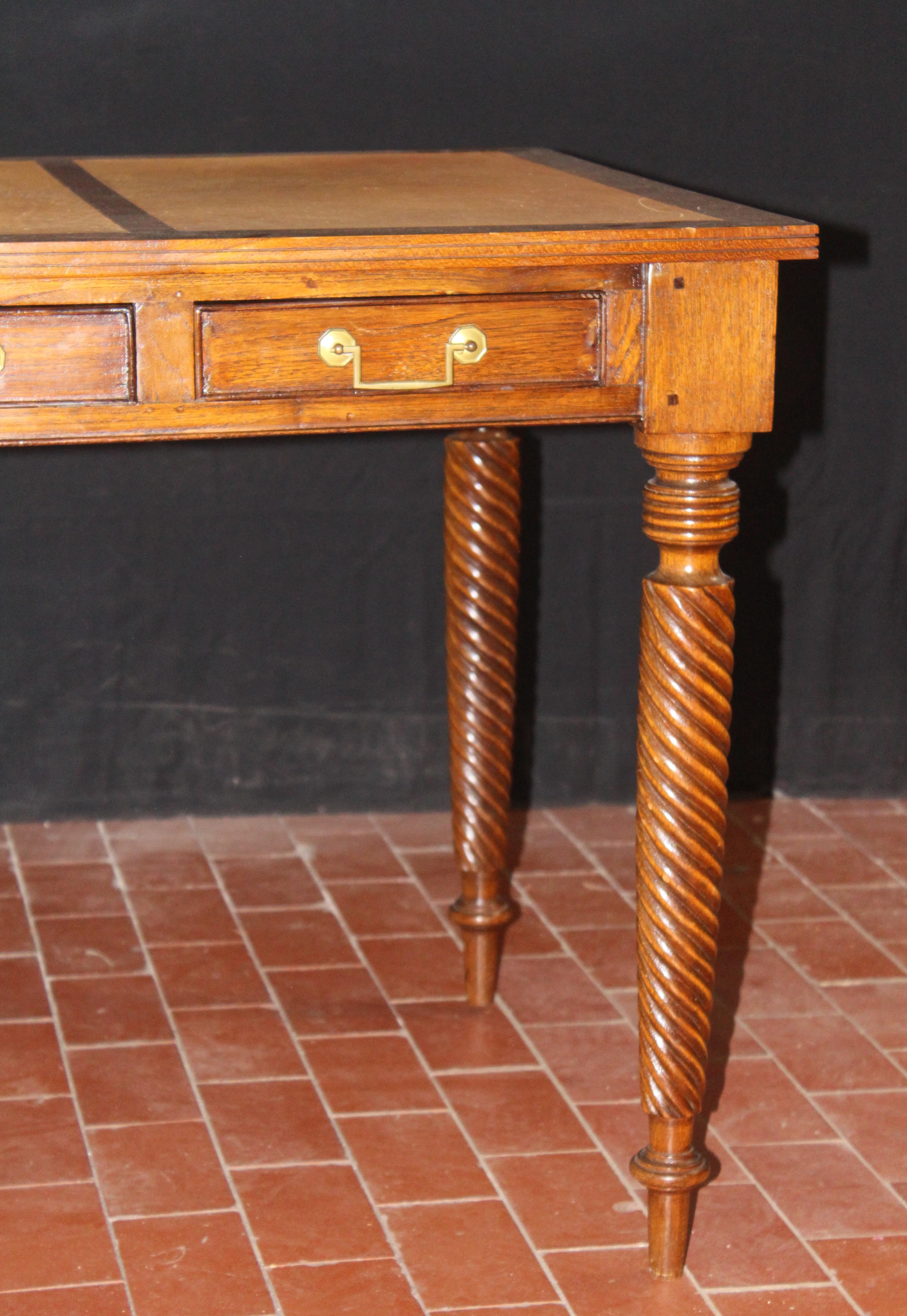 Leather in-laid 3-drawer mahogany desk with brass hardware with carved and fluted legs. The centre drawer is 23