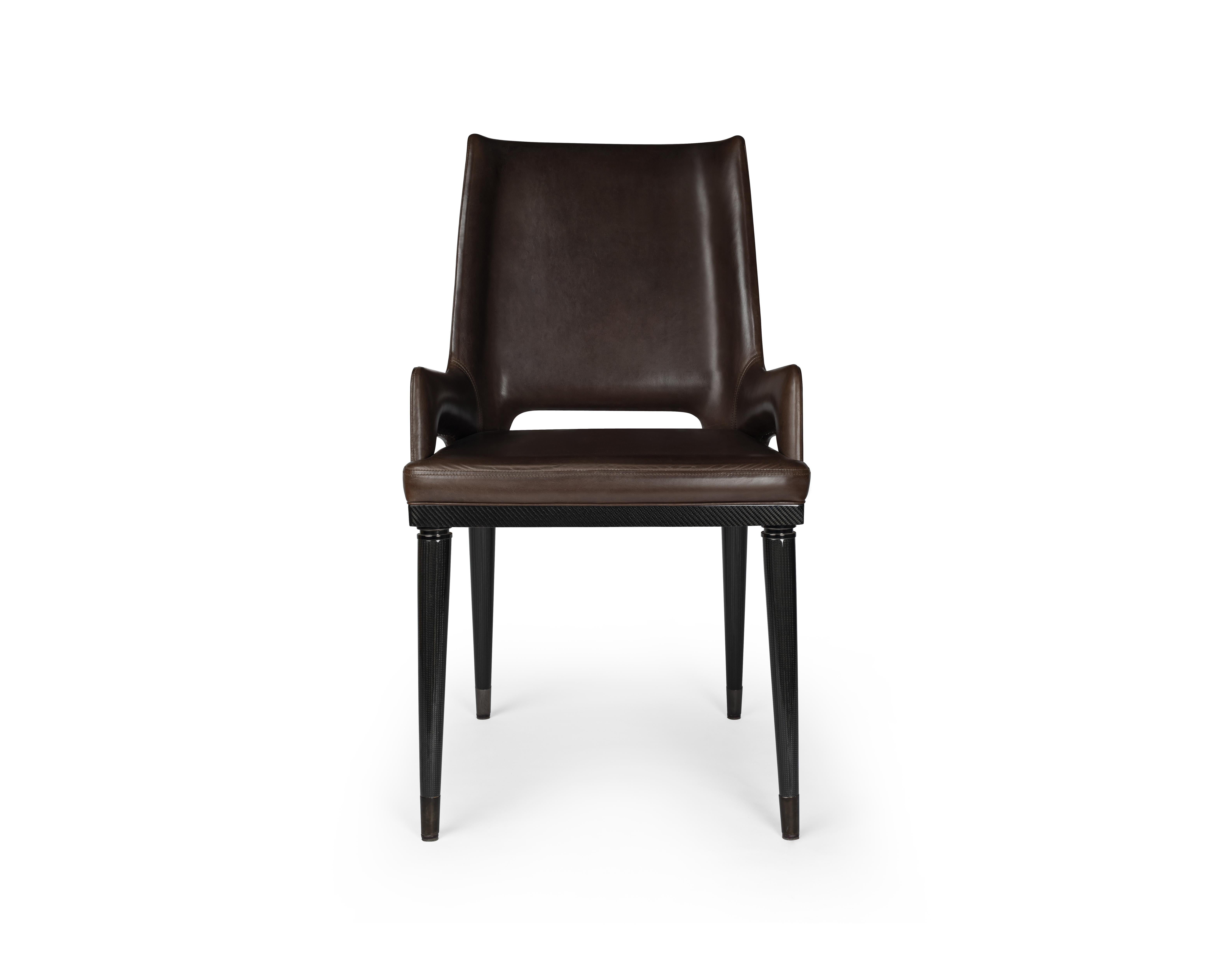 Leather Irving carver chair by Madheke
Dimensions: W 56 D 51 H 91 cm
Materials: leather, carbon fibre, metal

Carbon fibre chair back with upholstered seat. Seamless carbon fibre leg detailed with metal trim.

Reflecting the finest in
