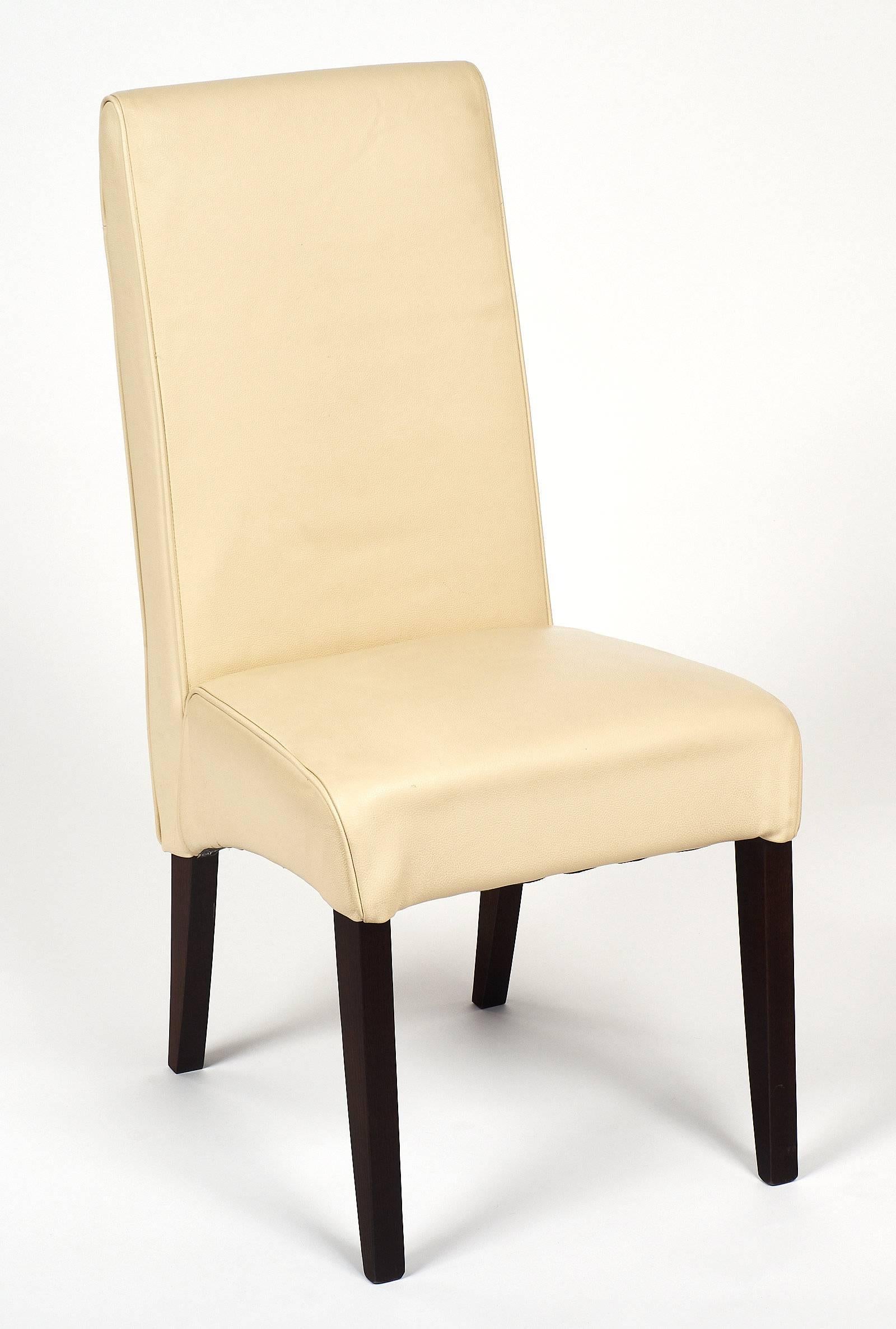 Comfortable set of Italian leather dining chairs covered in a rich, ivory colored leather. We love the tall backs and very strong craftsmanship.