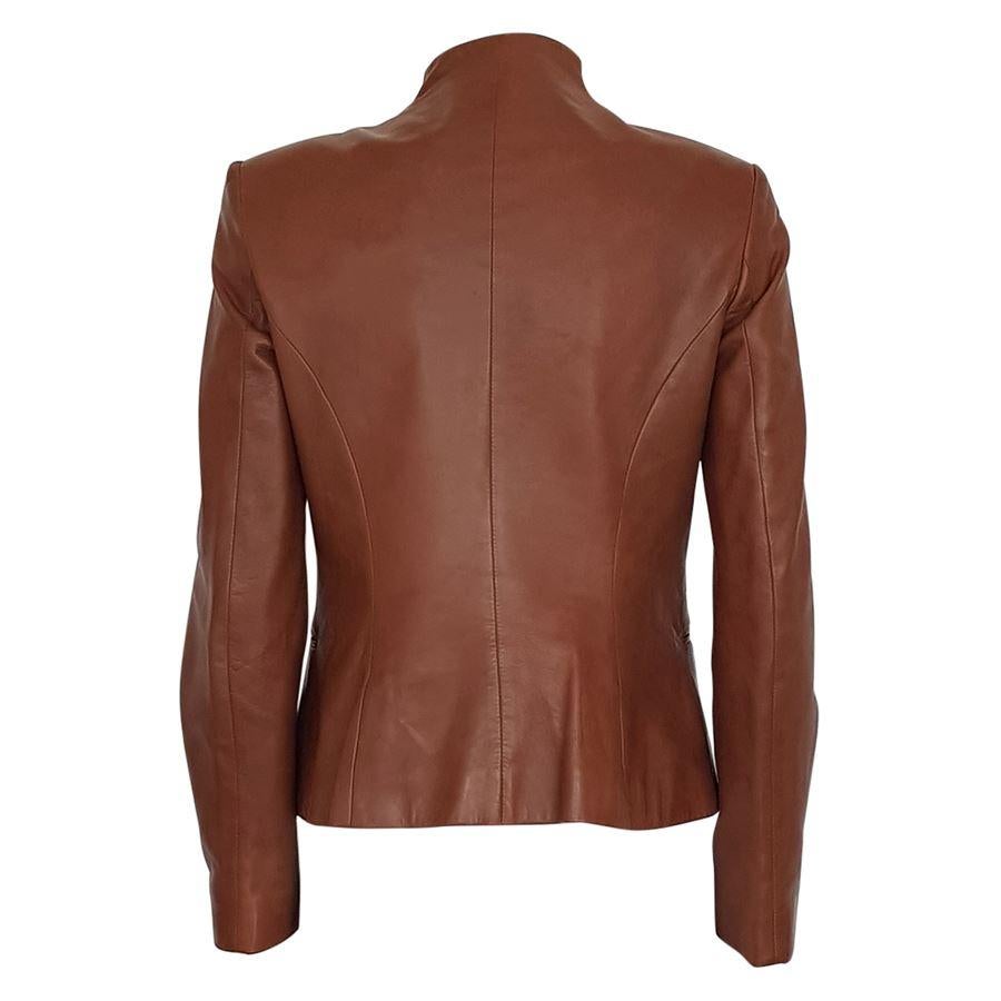 Lamb leather (100%) Cognac color Four buttons closure Two pockets Shoulder length / hem cm 54 (21.3 inches) Shoulder width cm 40 (15.7 inches) Presence of some spots on the back and the sleeve see pictures
