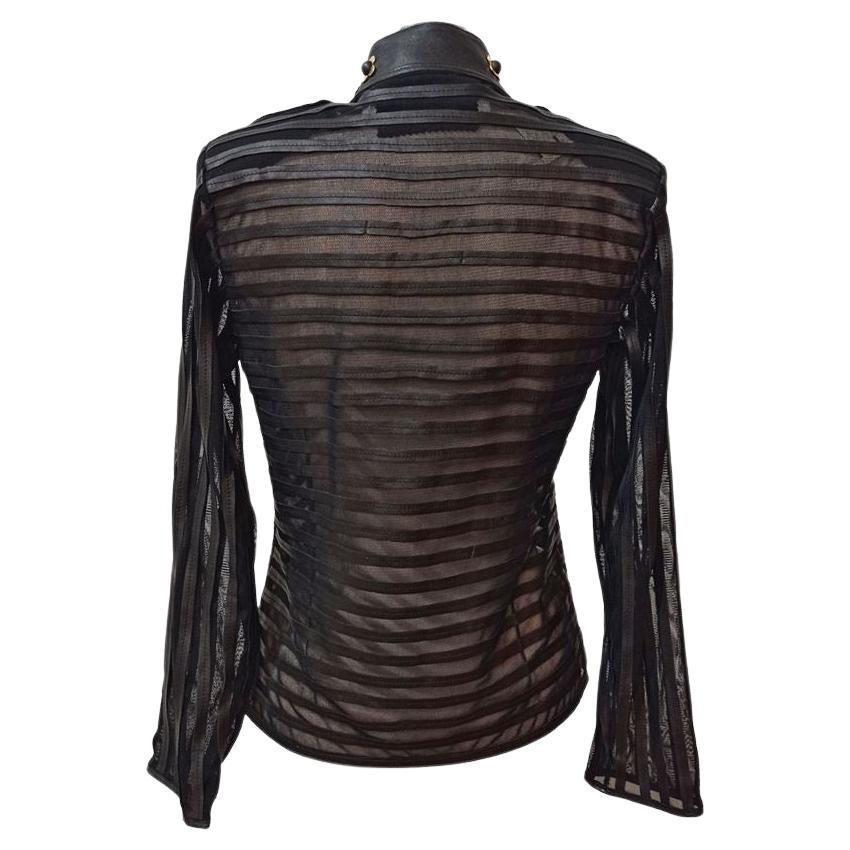 Lamb leather Black color Alternating strips of tulle and leather Hooks closure Long sleeves Metal and crystal details on the neck Length shoulder / hem cm 55 (2165 inches) Shoulder cm 37 (1456 inches)
