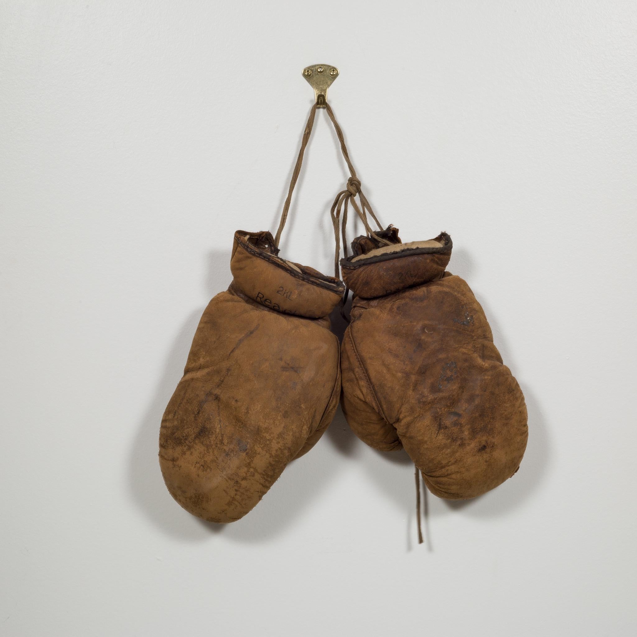 About:
This is a pair of turn of the century vintage junior boxing gloves by A.J. Reach Company, Philadelphia USA. The gloves come with original laces and the leather is in a stable condition with wear some wear from decades of use.

 Creator