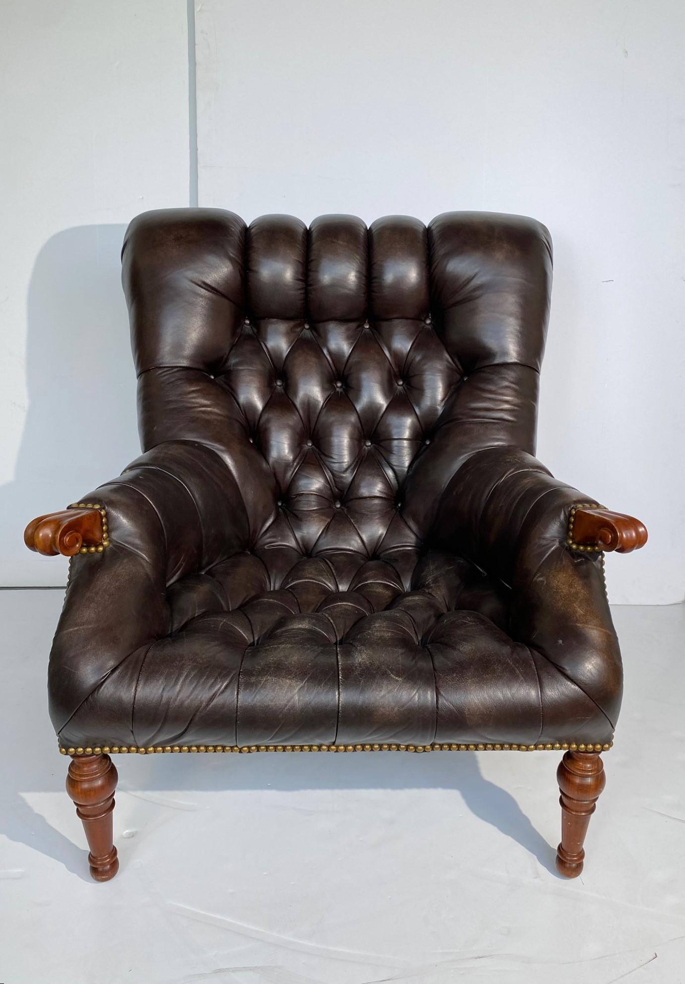 This remarkable chair is defined by its deep tufting and nailhead trim accents. A distinctive, gently sloping back and wraparound arms make it extremely comfortable, especially when combined with the coordinating ottoman. Arms carved from the finest