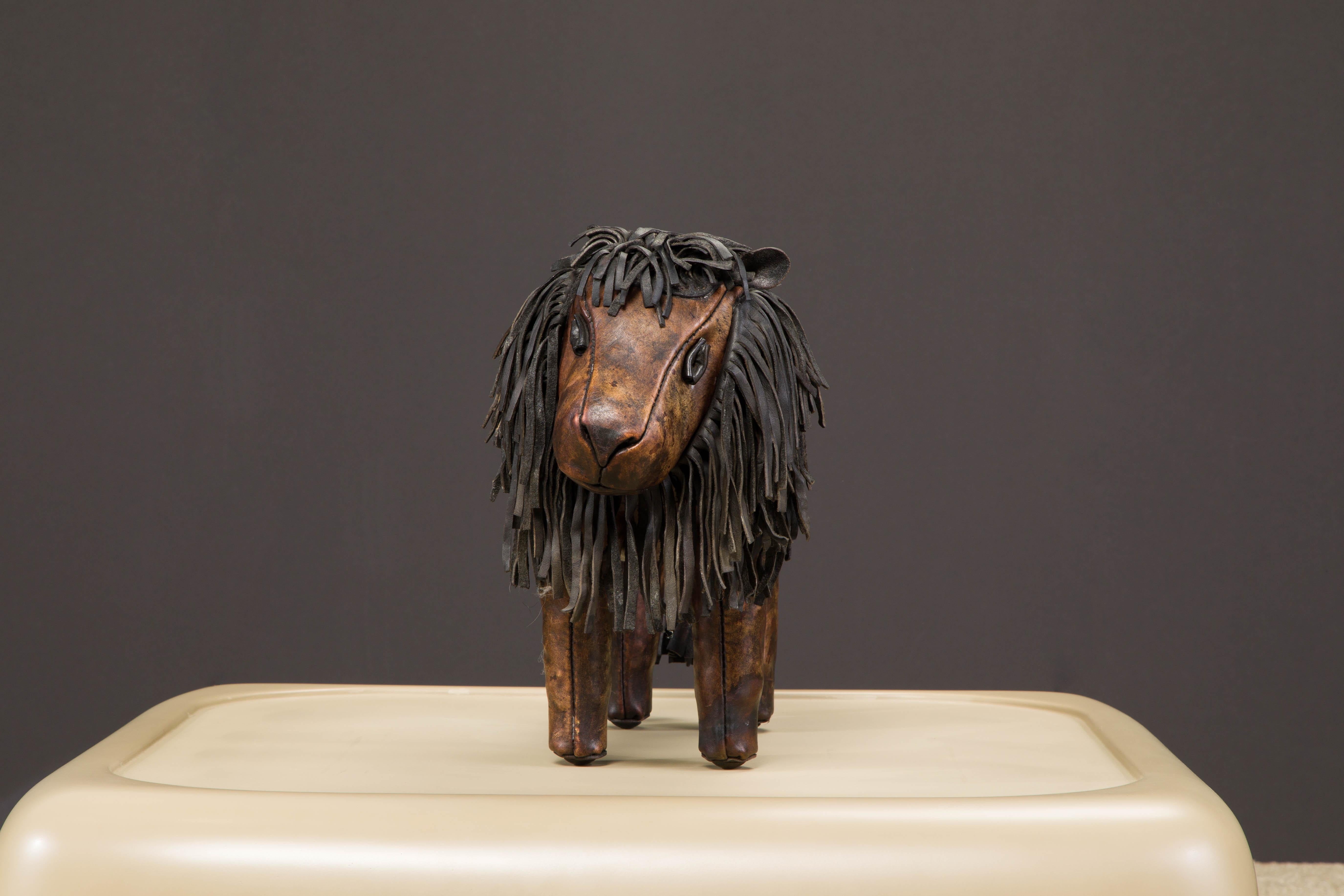 A wonderful collectors example of an original leather lion footstool by Dimitri Omersa for Abercrombie and Fitch, circa 1960s to 1970s. This example is signed with the 