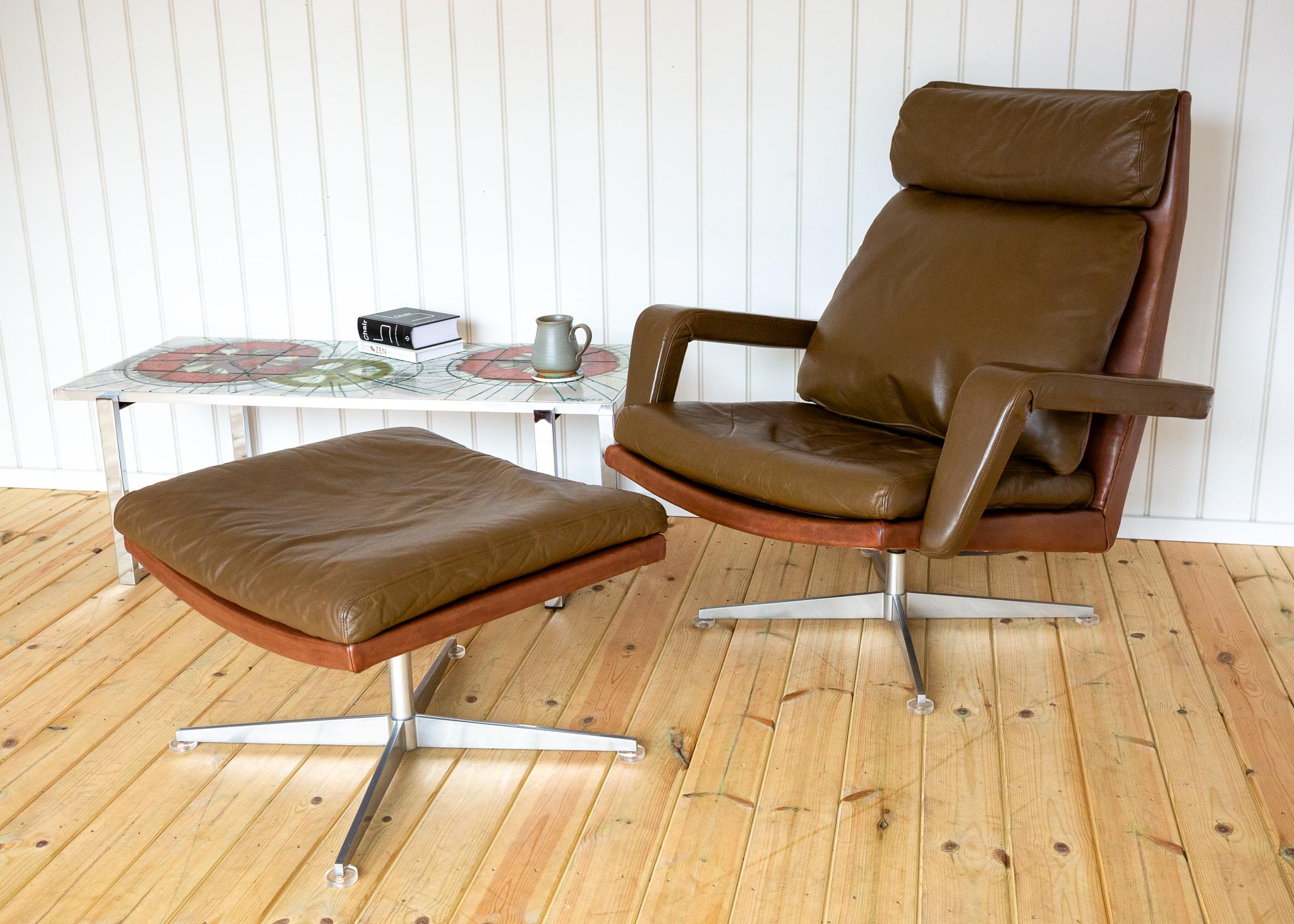 A strikingly attractive, excellent quality and extremely rare Mid Century European designer swivel lounge armchair and matching footstool in lovely vintage condition. Made in the late 1960s and designed by heralded German designer Hans Kaufeld, this