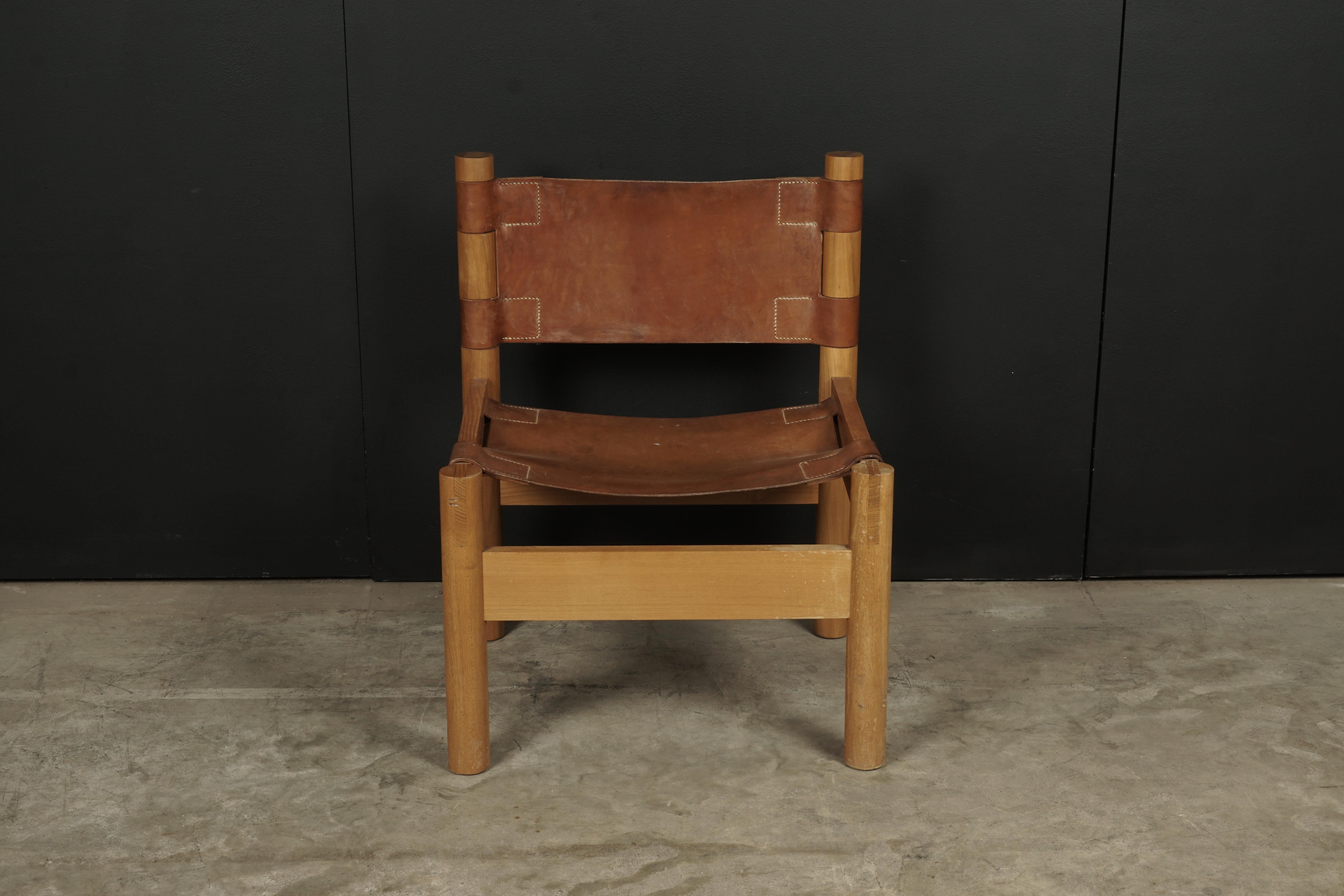 Rare leather lounge chair from France, circa 1970. Solid frame in elm stretched with thick cognac colored leather.