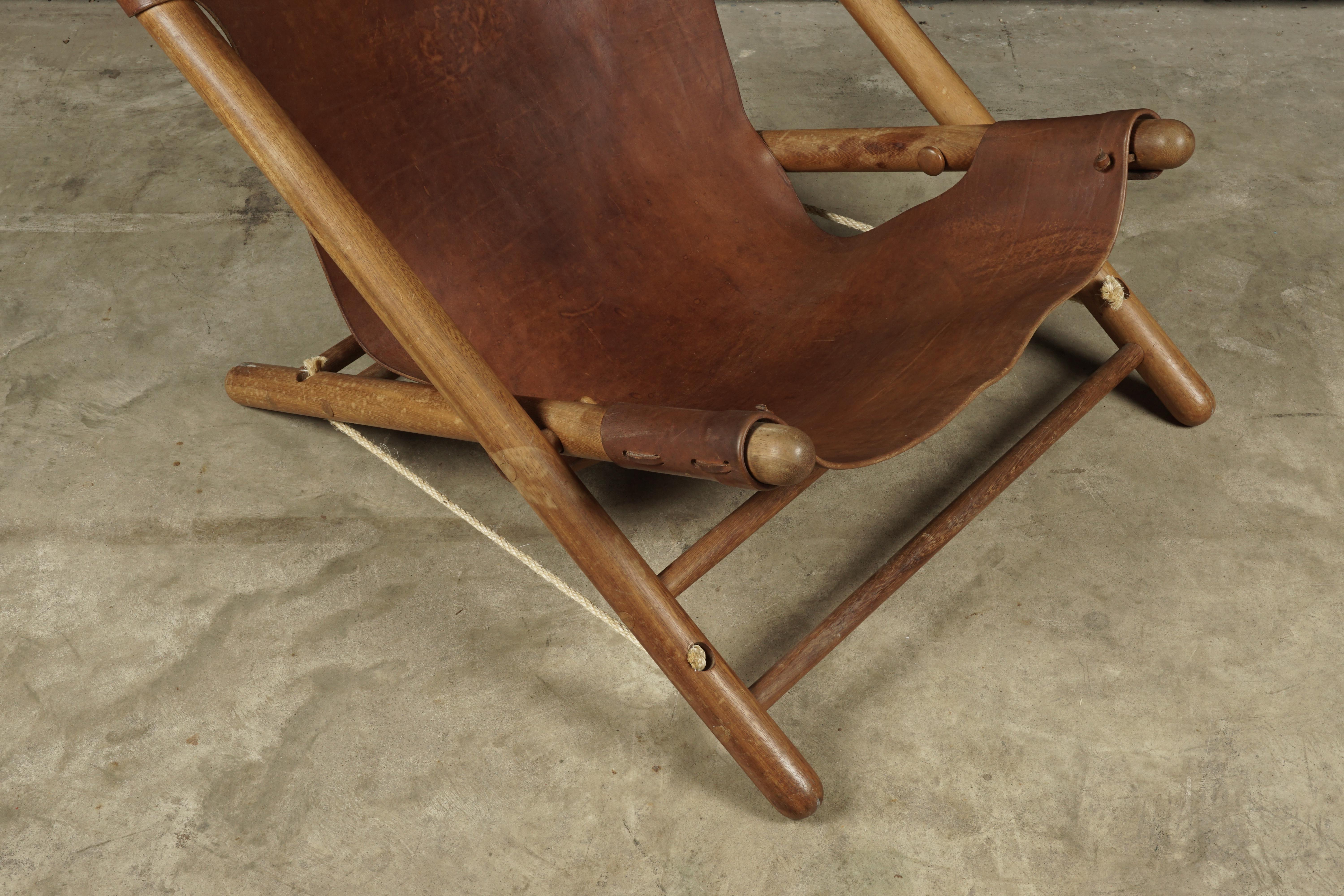 Vintage leather lounge chair from France, circa 1970. Rare foldable model with thick patinated leather. Nice patina and wear.