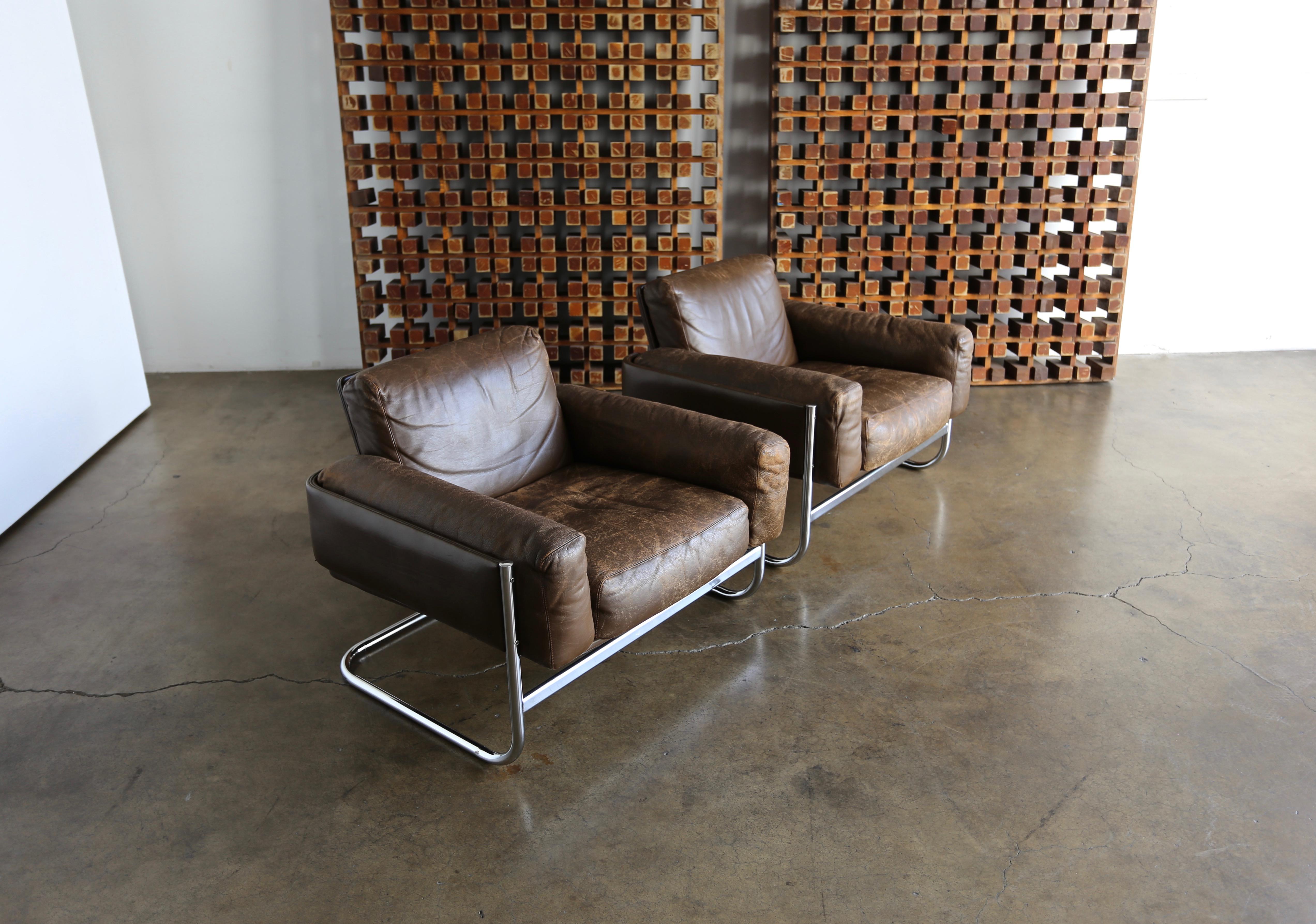 Pair of leather and chrome lounge chairs by Sven Ivar Dysthe for Dokka, circa 1967. Nice patina to the original brown leather.