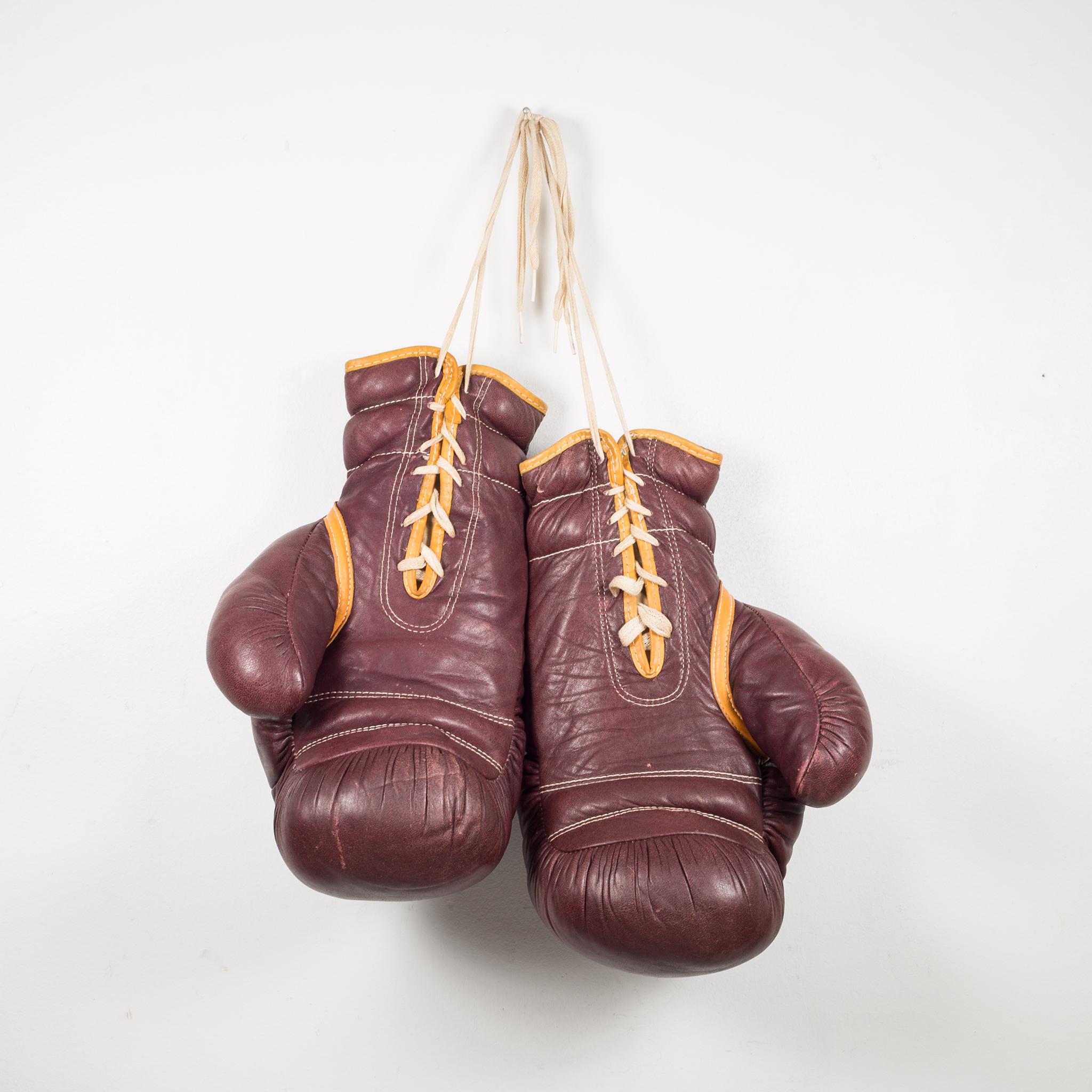 About

A pair of large vintage leather boxing gloves. The boxing gloves are soft brown leather with gold leather piping, yellow laces and 