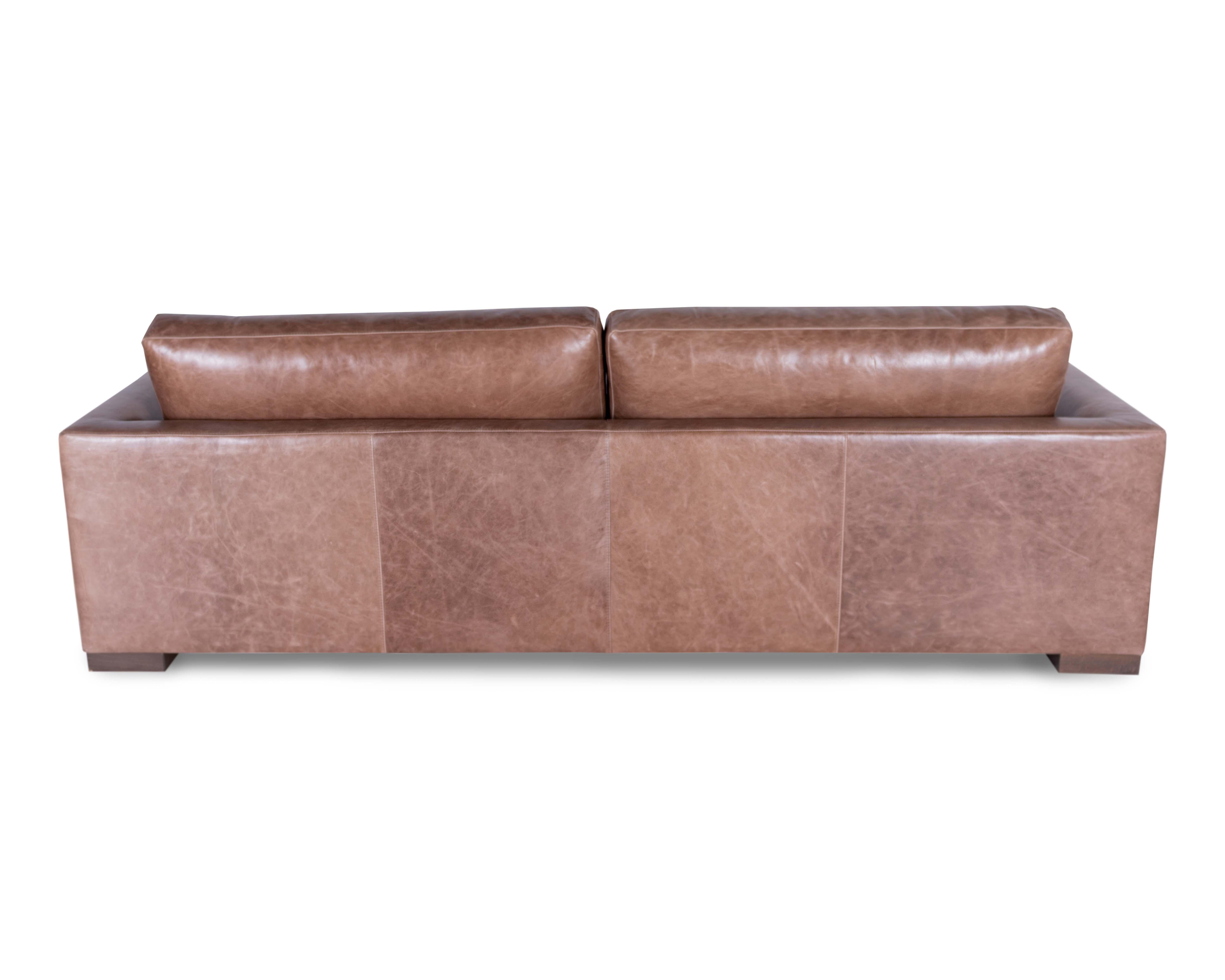 The Marfa low leg sofa and sectional takes shape from the rolling hills of west Texas as the interior arm subtly tapers from the top of the arm into the seat. The sofa lies upon a thick refined wooden block leg. The forms and shapes of the cushion