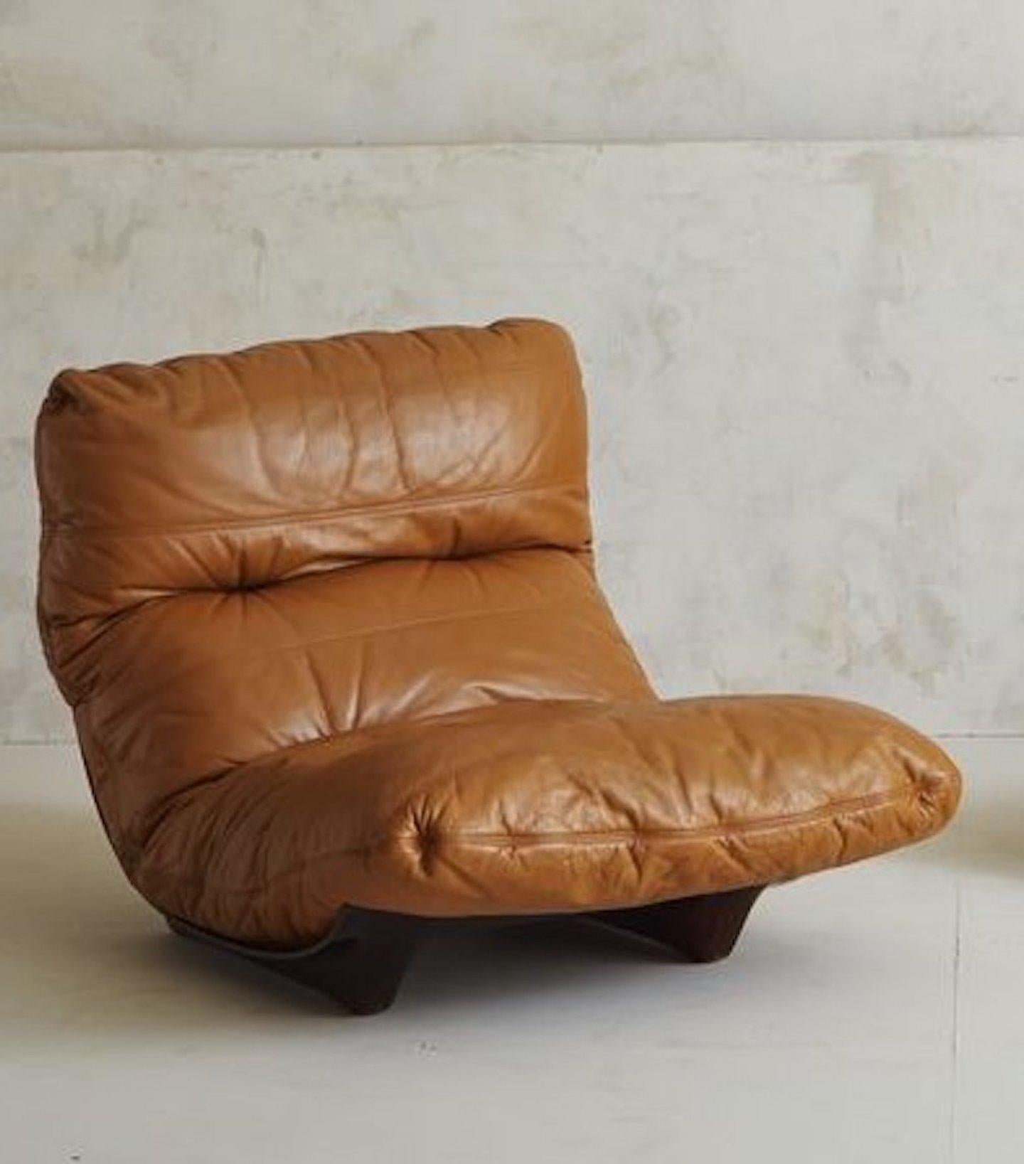 Designed by Michel Ducaroy for Lignet Roset, the Marsala chair features a sculptural amber plexiglass frame that is entirely curved. This Marsala chair has a gorgeous cognac leather upholstery. Priced individually, one available.