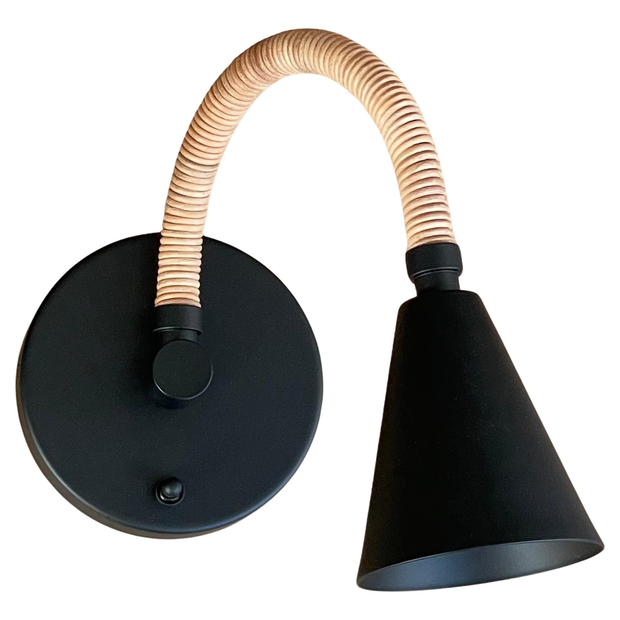 Leather wrapped flexible arm wall light you can pose and adjust as you wish. This is our updated Meander Reader light with larger cone shade and new upward angled flex arm. 
Shown here in Matte Black powder coat finish and Natural Leather.
Choose