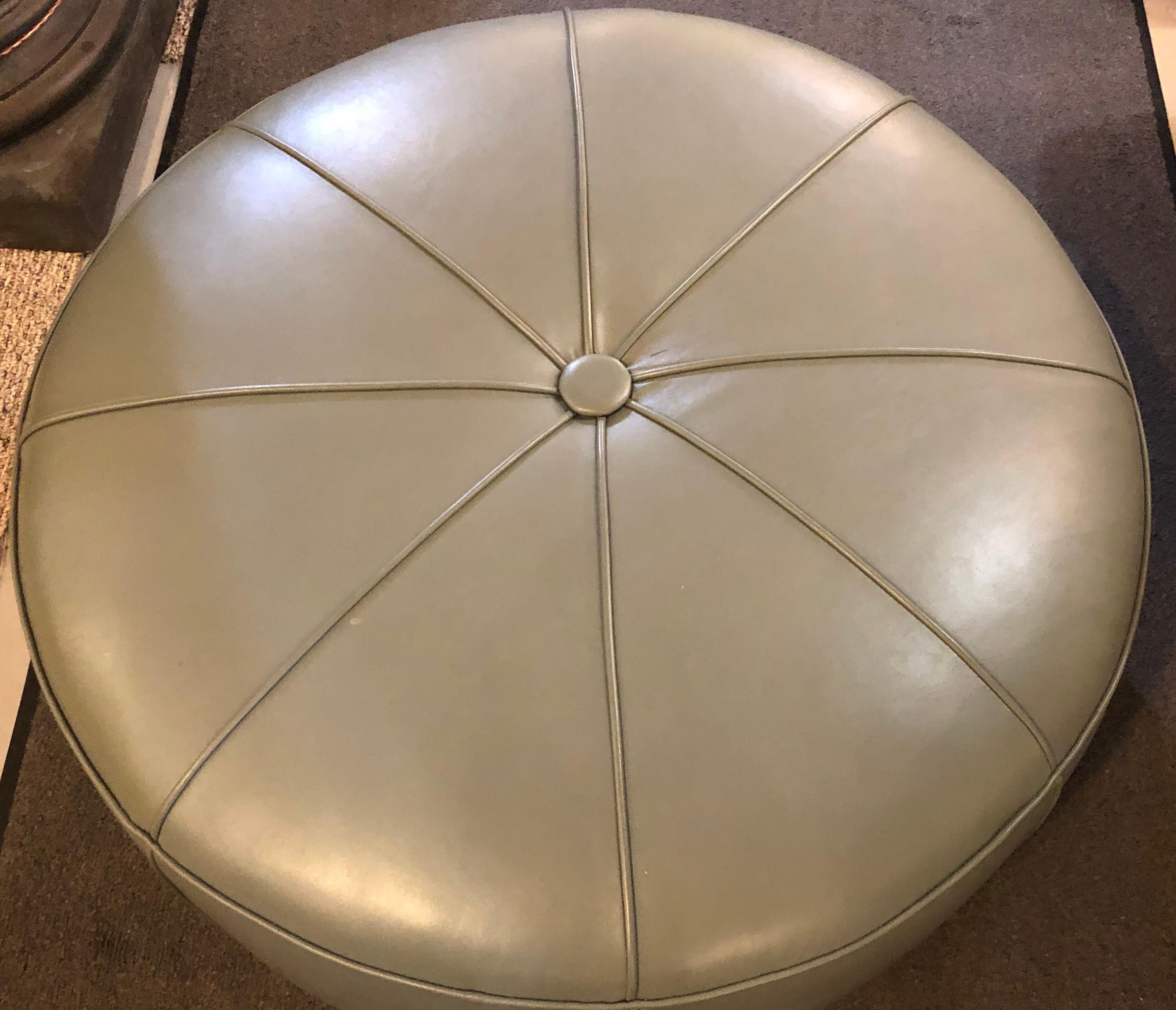 Leather modern mint ottoman or pouf in pie form. Fine clean lines on this sleek and stylish designed ottoman or footstool that would easily fit into any decorative space.