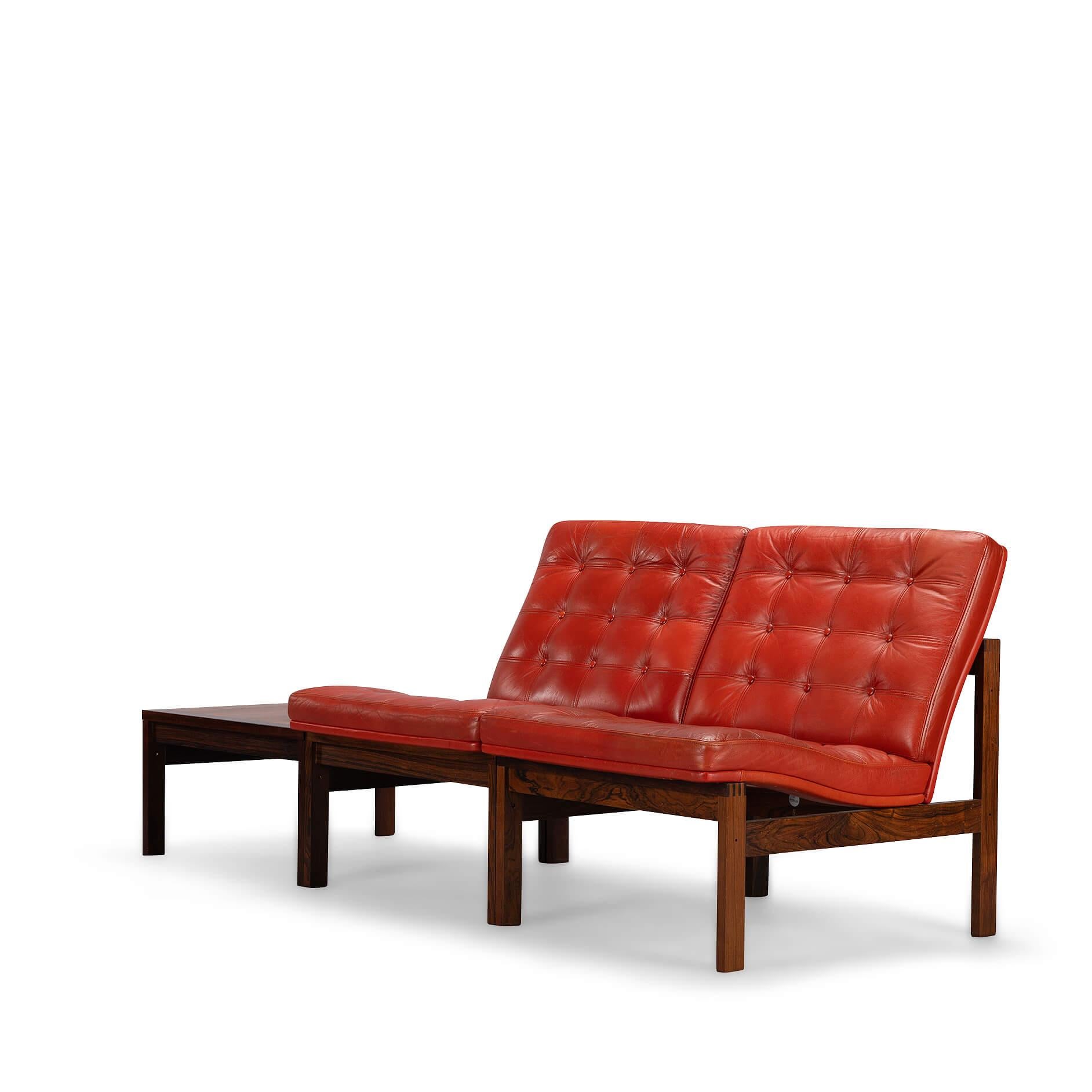 Supercool set of red leather and rosewood Moduline easy chairs designed by Ole Gjerlov Knudsen & Torben Lind for France & Son, Denmark 1962. The frame is made in rosewood, with remarkeble fingered connections on the corners. The seats are in the