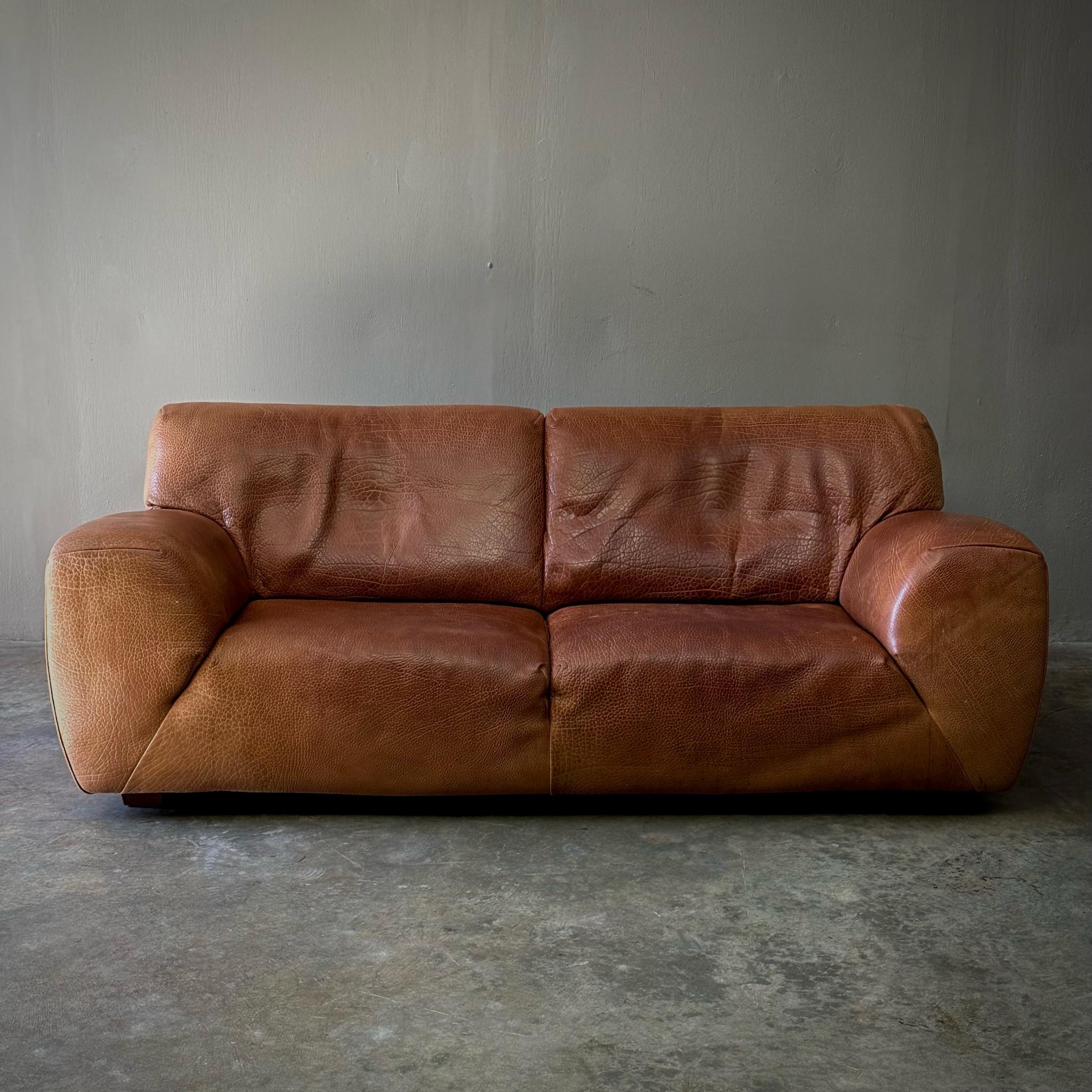 1970s Molinari leather sofa, upholstered in original chestnut leather. Handsome and luxurious with a cool, clean silhouette. In many ways Molinari could be considered the Italian counterpart to Swiss design manufacturer Desede, for its use of