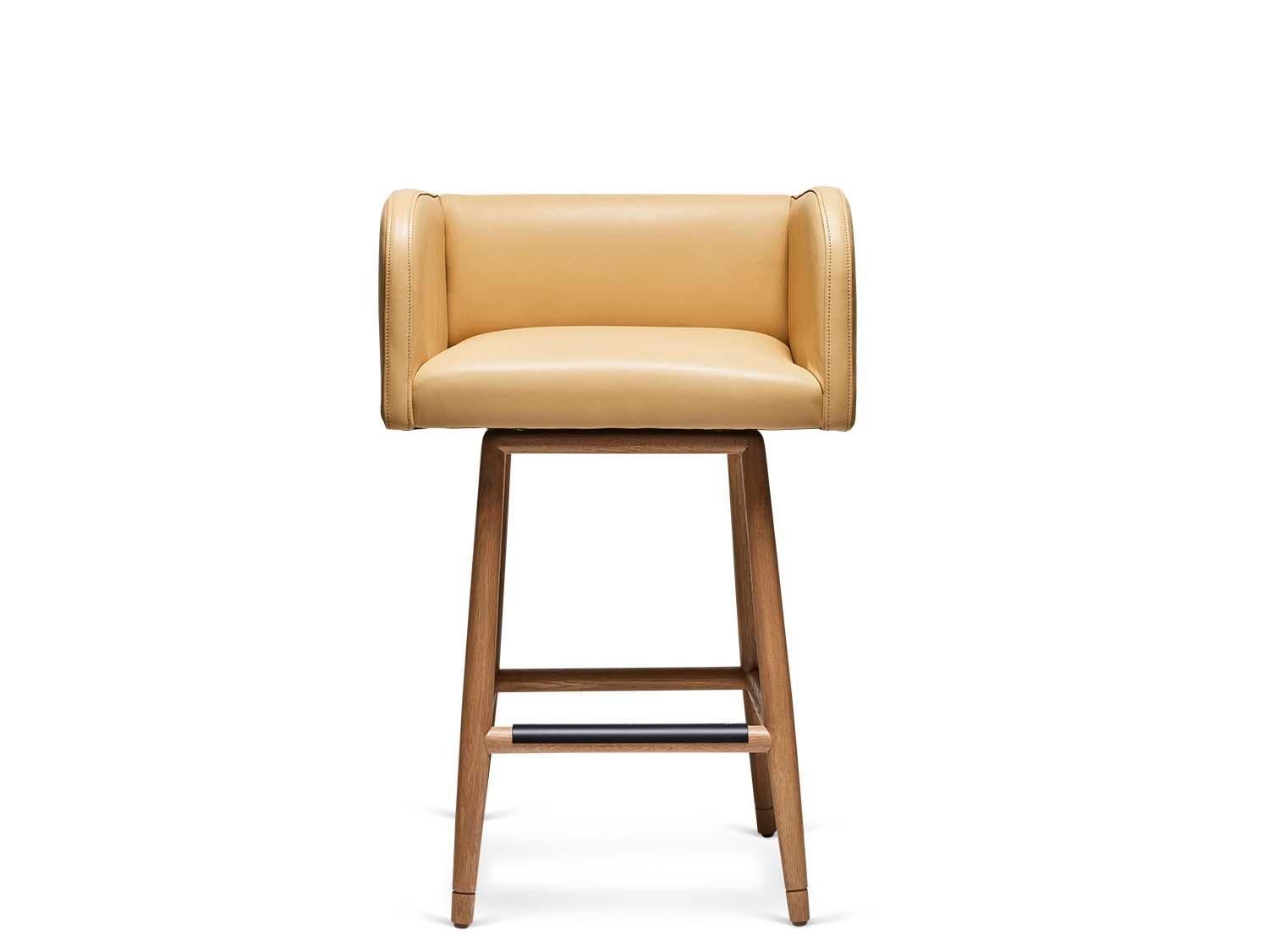 The Moreno Barstool with swivel sits low with Italian inspired arms and incised details on a solid walnut or oak base. Available to order in counter height. 

The Lawson-Fenning Collection is designed and handmade in Los Angeles, California. Reach