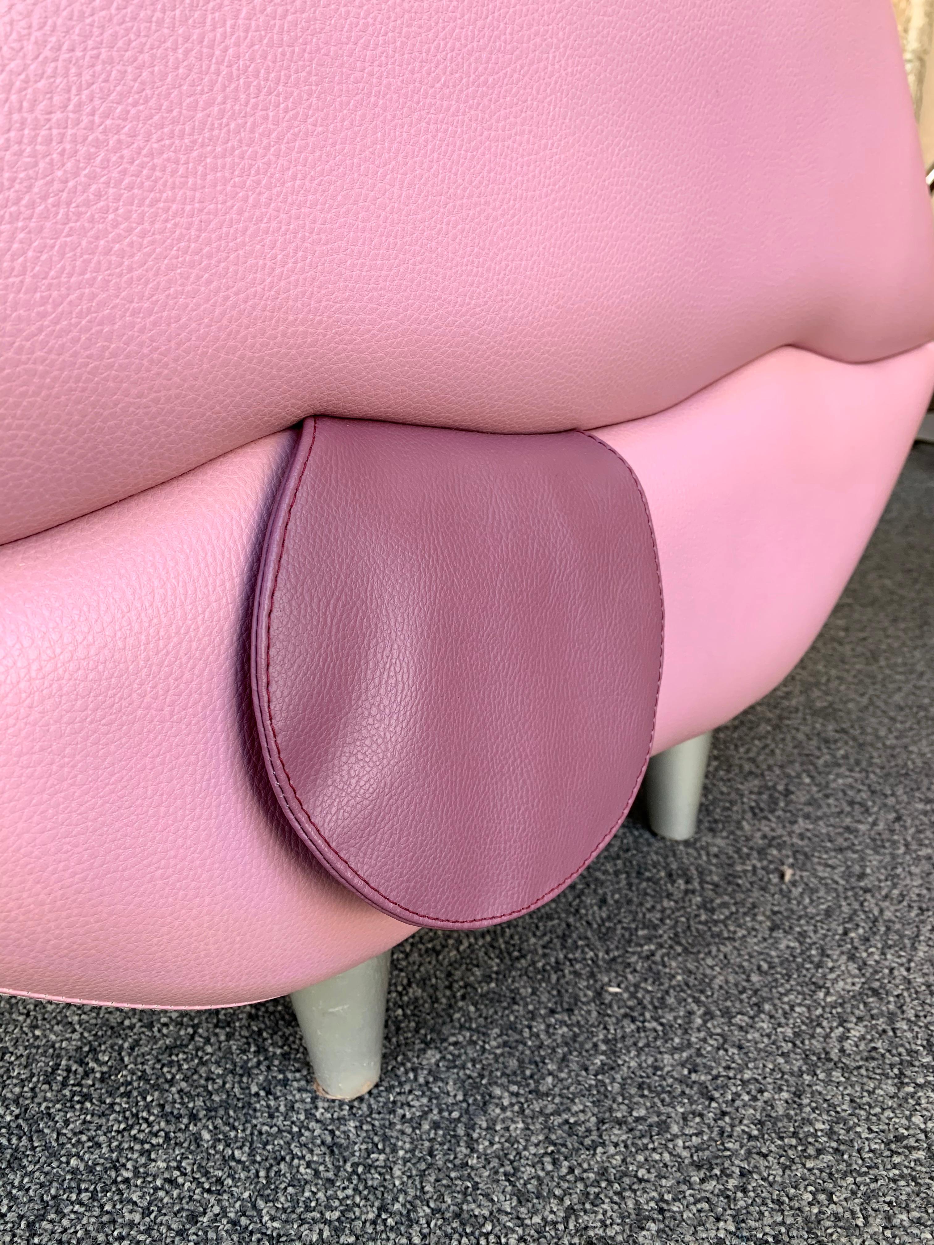 Pink and purple leather mouth pouf stool or ottoman.