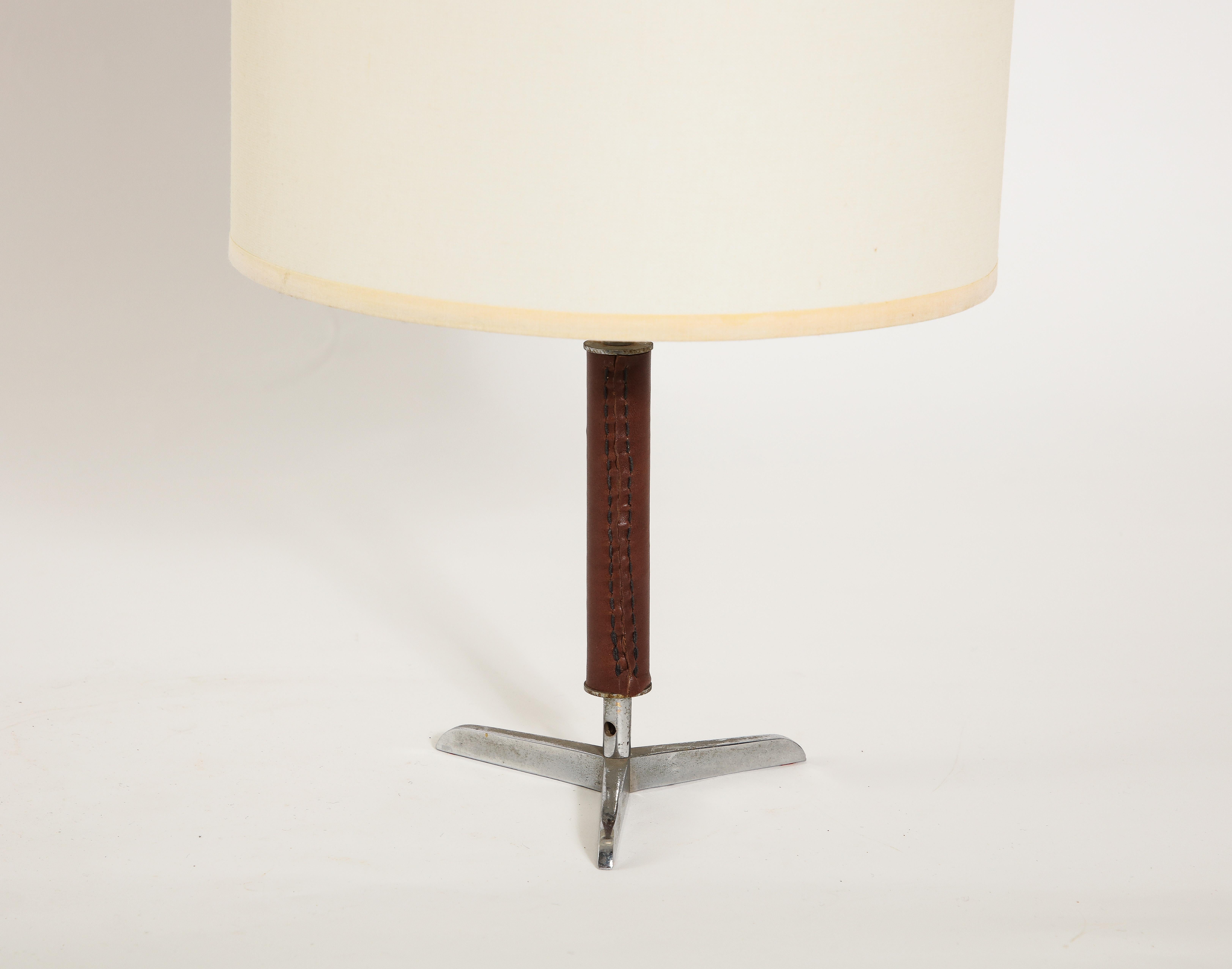 Tripod nickel table lamp with a brown leather trim.

12x5 base Only