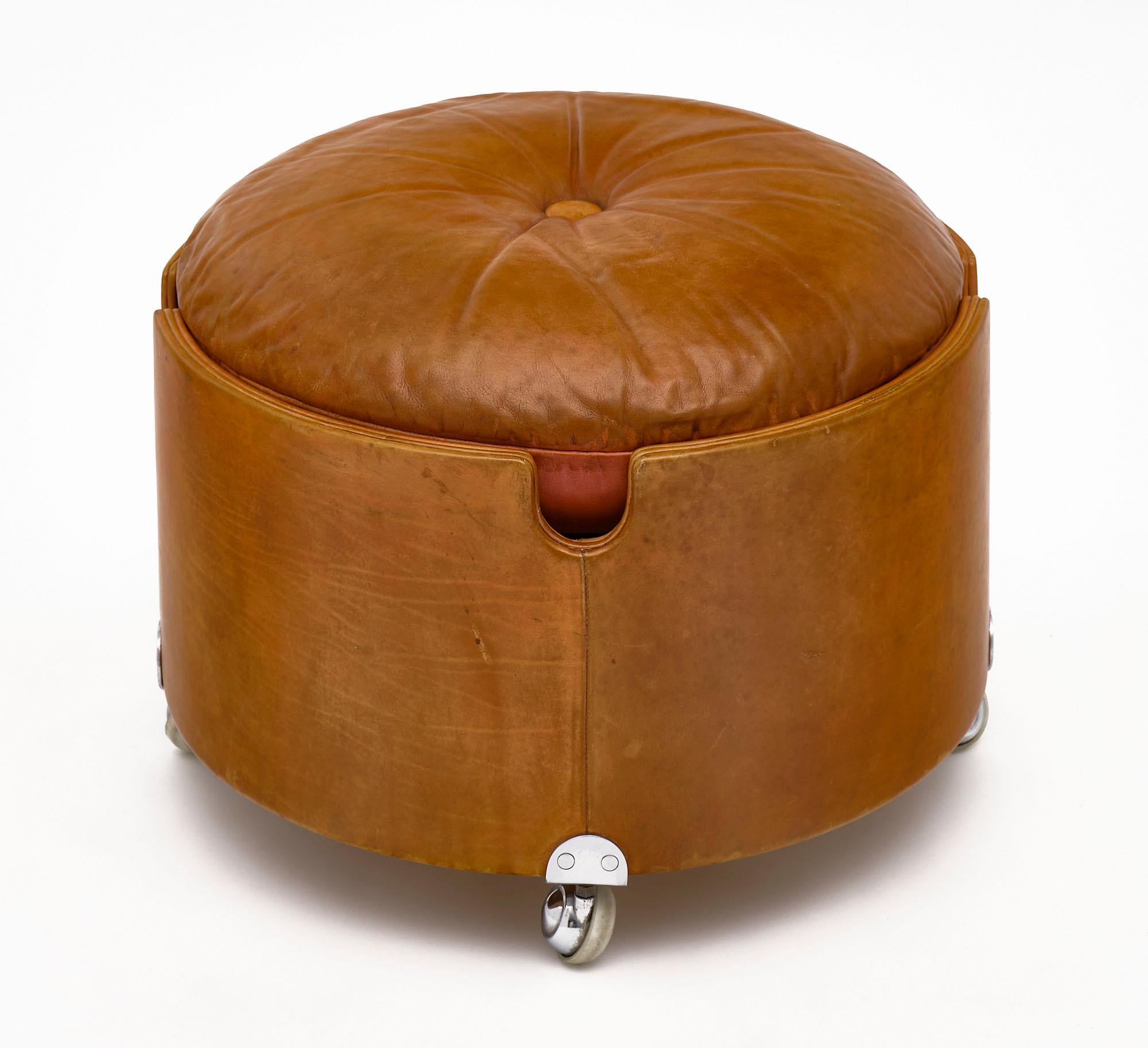 Leather ottoman by iconic Italian designer Poltrona Frau. This comfortable and versatile ottoman features chromed steel casters and the original leather upholstery in very good condition.