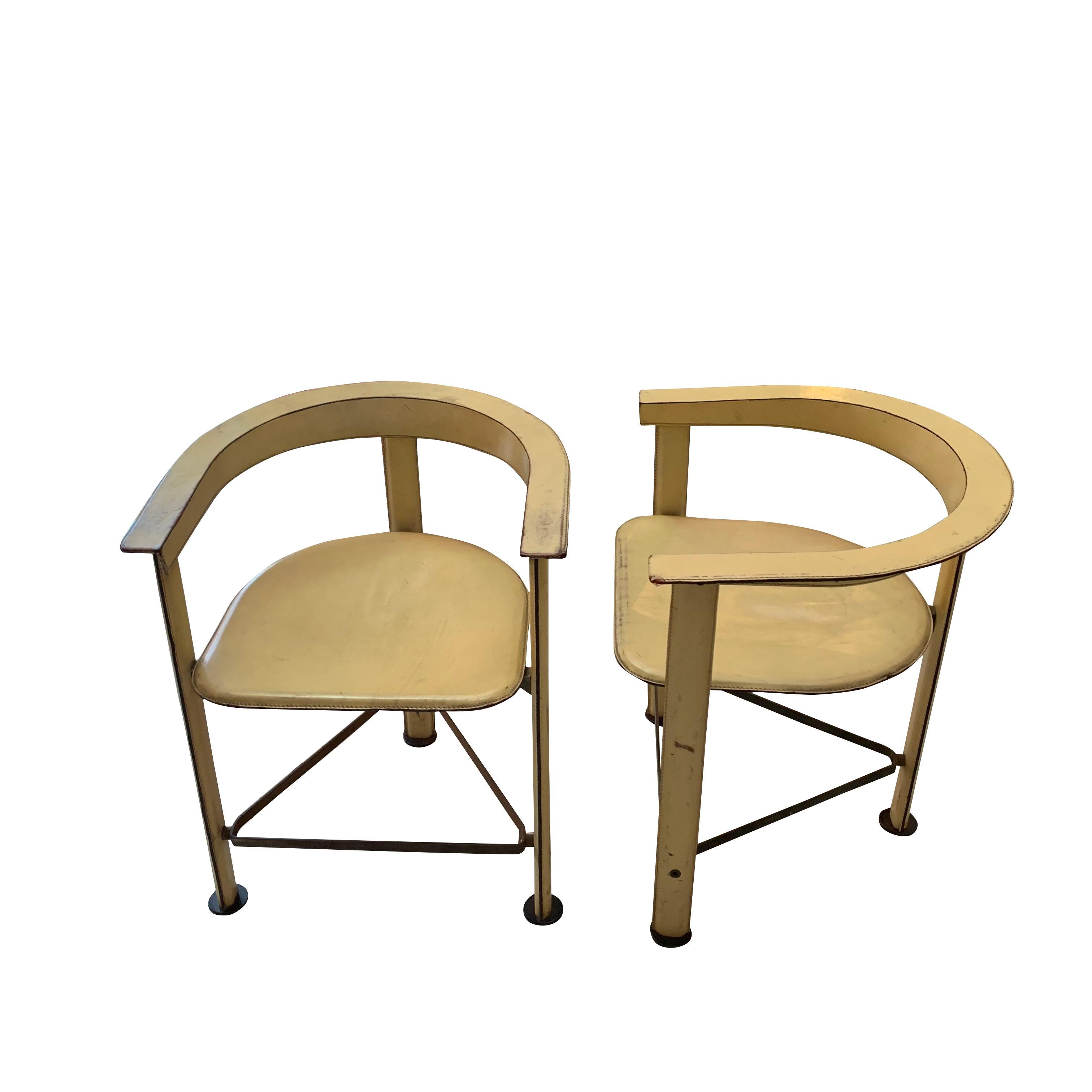 1970s Moroccan pair vellum colored leather chairs
Curved back seat
Aged brass footings.
  