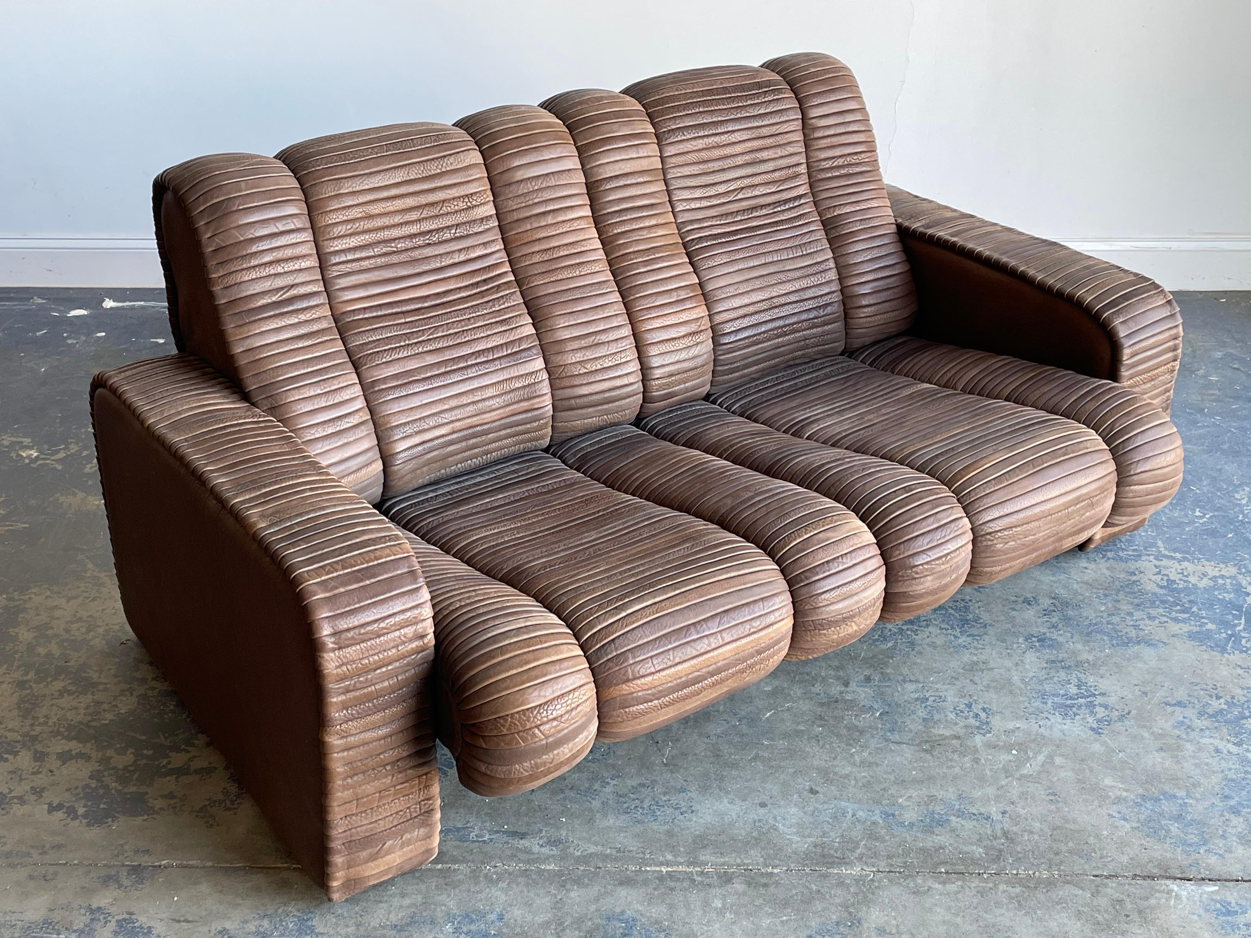 An unusual leather sofa designed by Ernst Lüthy between 1962-1964, who went on to form De Sede in 1965. 

Sofa consists of thick leather strips throughout creating an interesting and organic design. Sofa is incredibly well built, as De Sede has