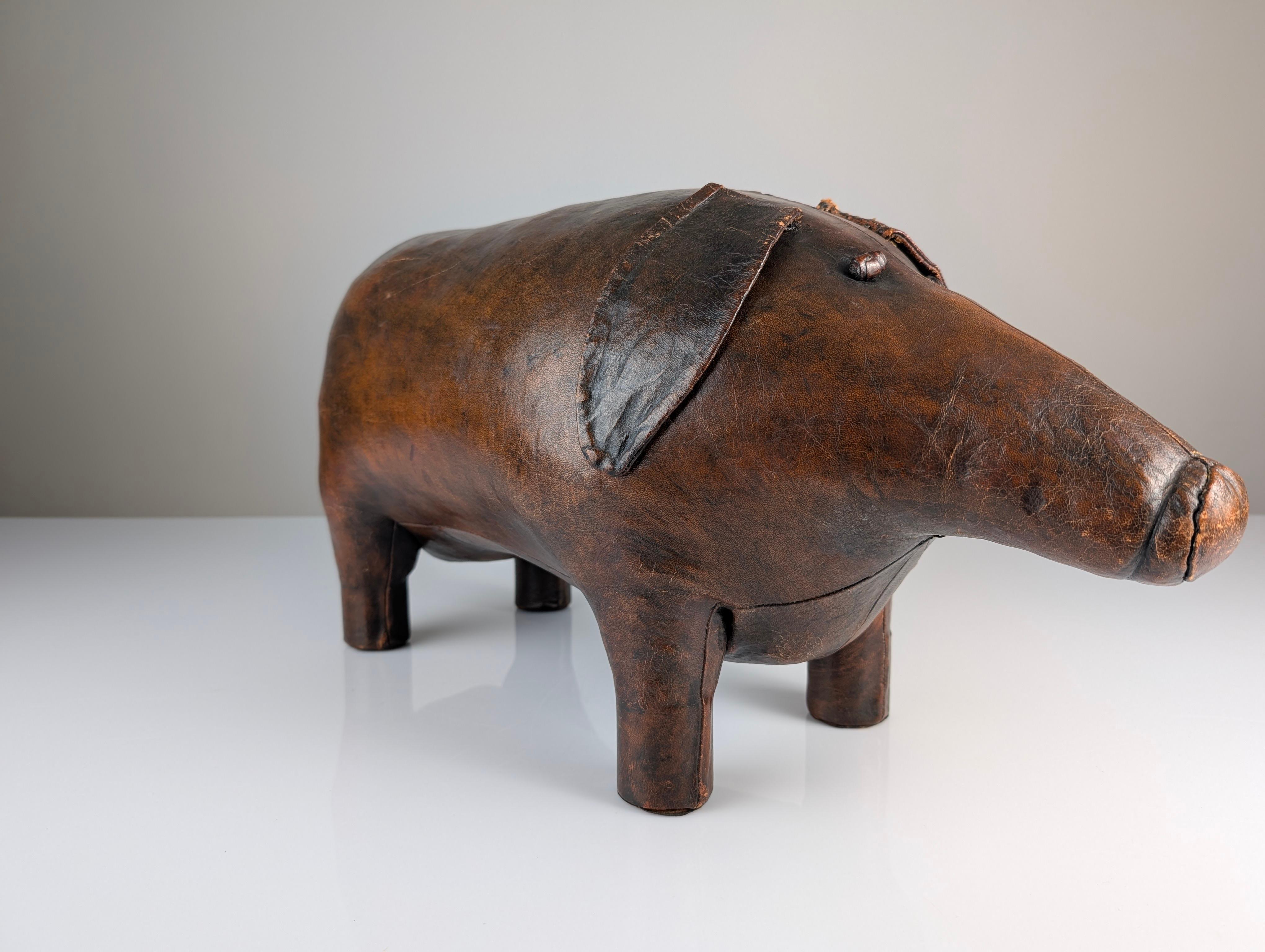 This charming pig-shaped ottoman, designed by Dimitri Omersa in the 1960s, is a classic piece that brings style and character to any space. Crafted from genuine leather with a beautiful natural patina, this stool combines functionality with