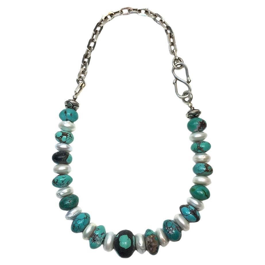This is a leather-polished turquoise and freshwater pearl necklace & earrings set. Nouveau Boutique created this single strand necklace with unusual leather-polished up to 14 x 20 mm turquoise beads and 7 x 14 mm large freshwater button shaped