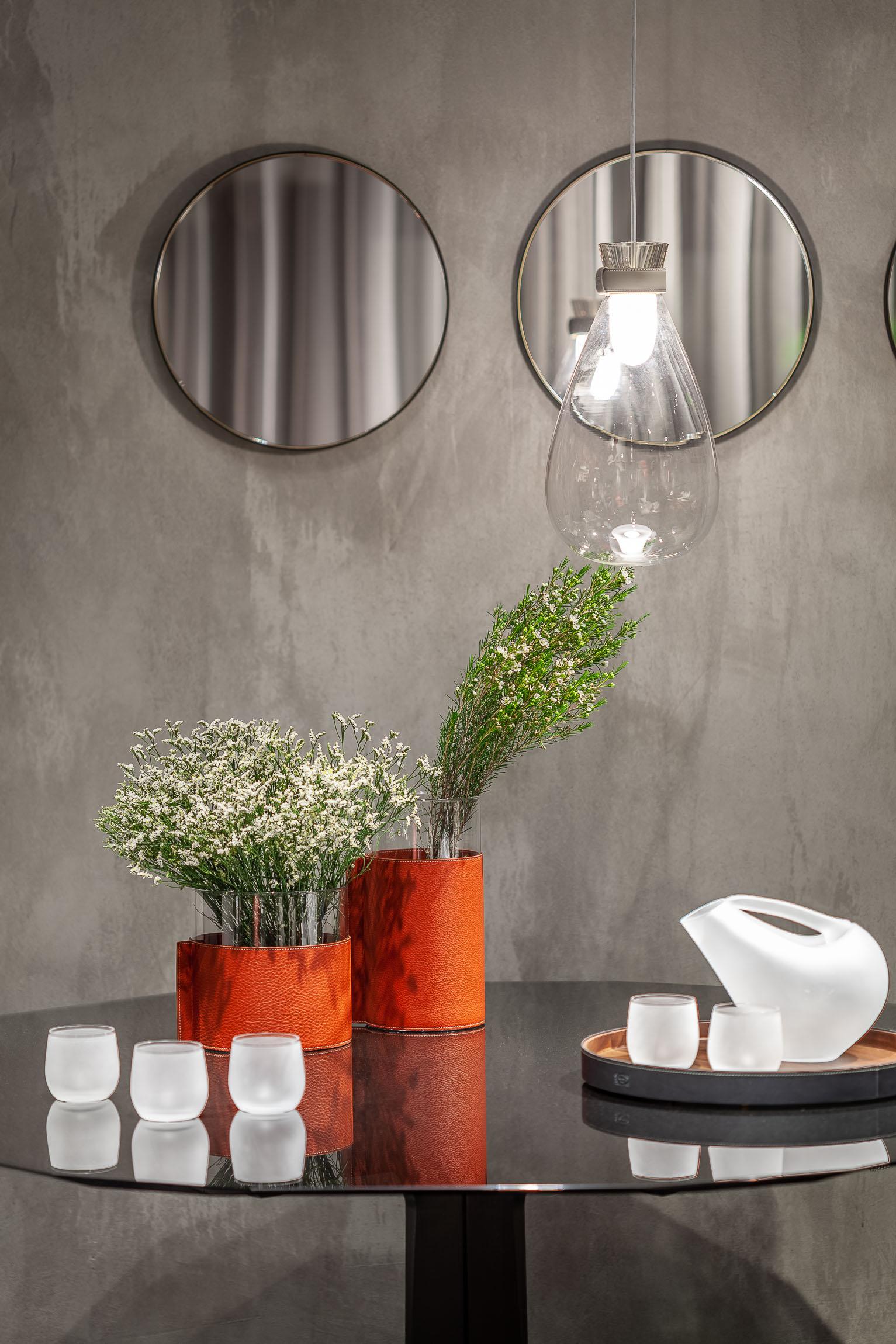 Leather pot is a transparent glass and soft leather for a family of open vases that can be mixed and matched or used on their own. The Leather Pot vases collection, designed by Poltrona Frau, consists of three simple transparent glass cylinders in
