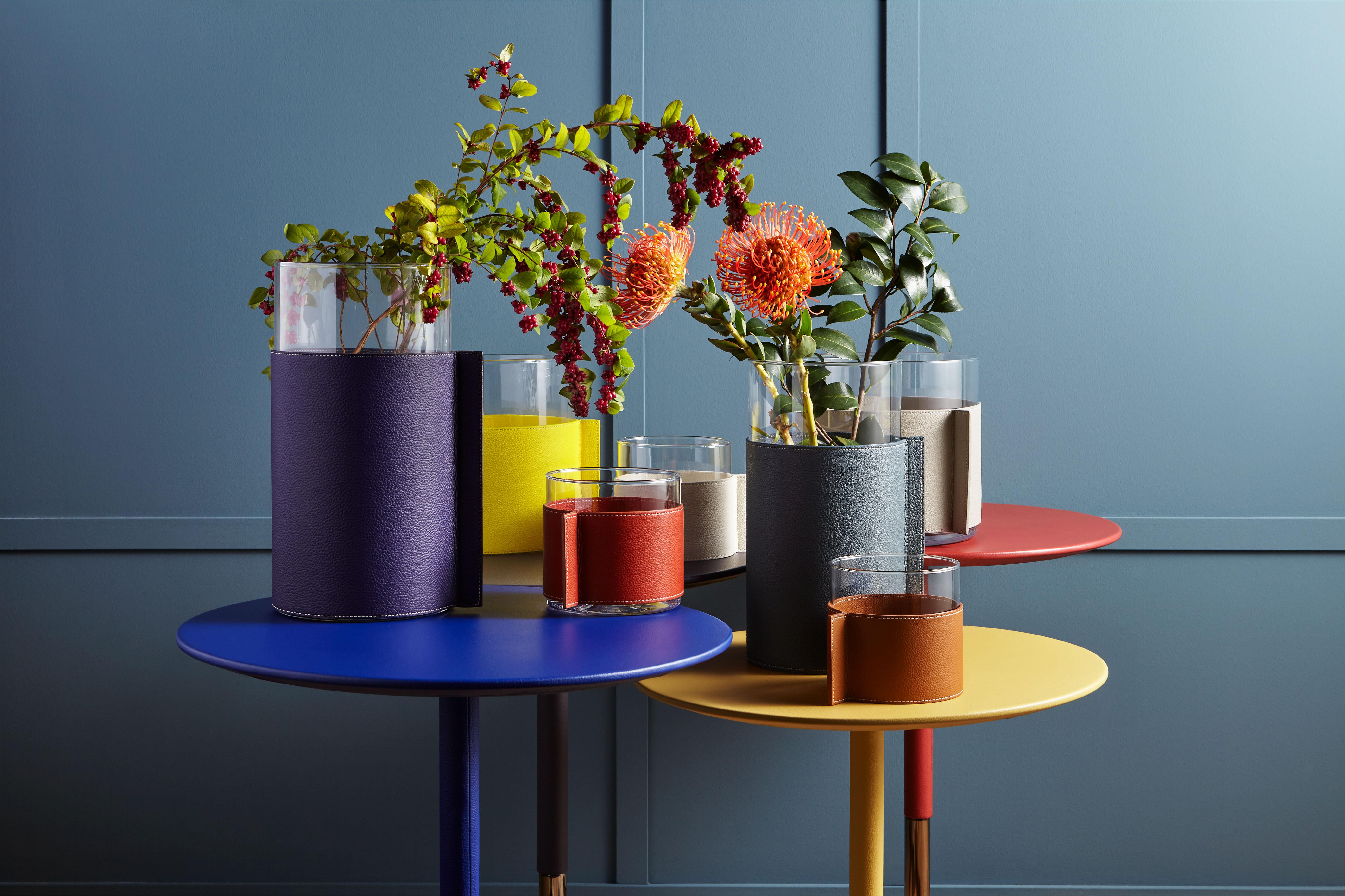Leather pot is a transparent glass and soft leather for a family of open vases that can be mixed and matched or used on their own. The Leather Pot vases collection, designed by Poltrona Frau, consists of three simple transparent glass cylinders in