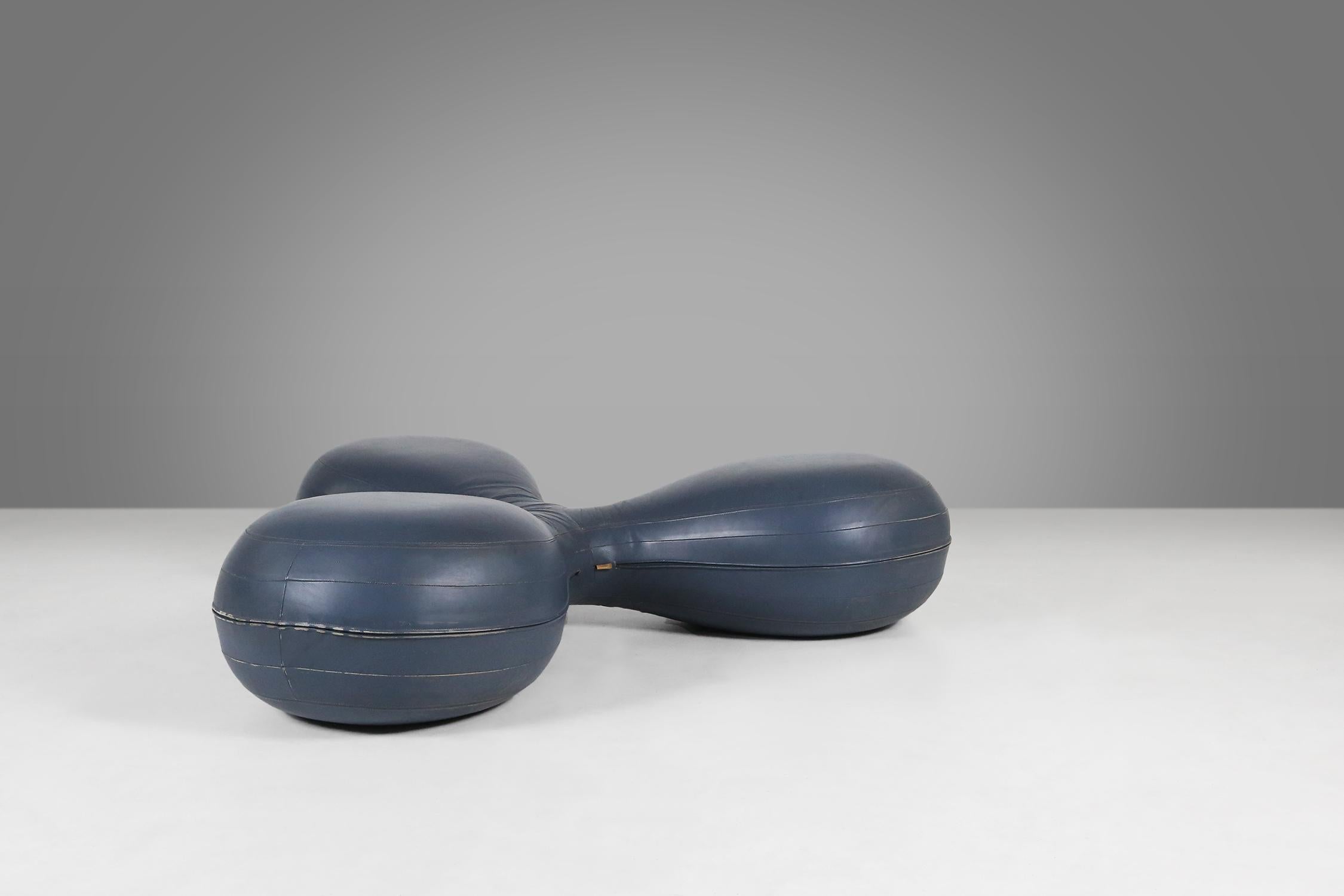 This pouf has an innovative design with three connected round sections that add a striking and modern element to your interior.

The pouf is upholstered in dark blue leather that is durable and easy to maintain. The visible stitching details add to