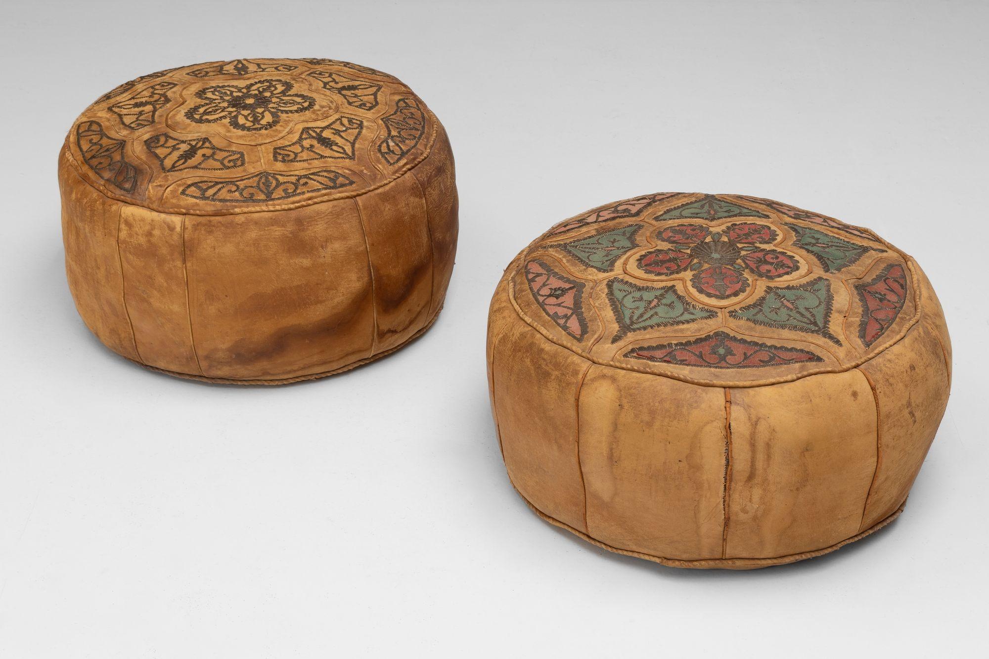 Pair of decorative leather covered pouffes with embroidered decoration. Circa 1930.

H 29cm x W 60cm x D 60cm