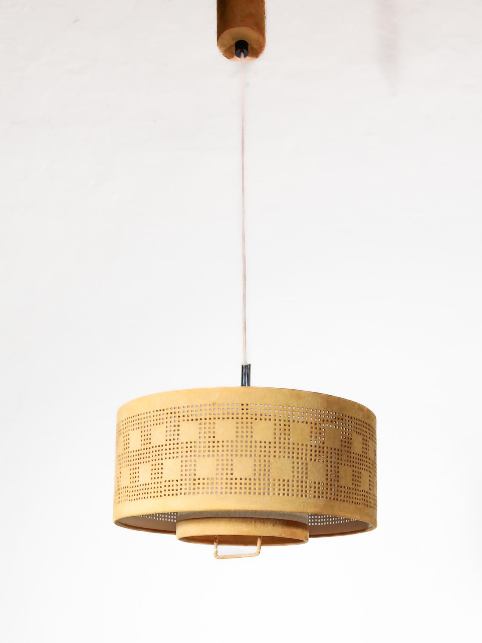 Beautiful leather pull lamp with suede shade. Handmade and hand-stitched. Designed by Charlotte Wawer for home lighting in Germany in the 1970s. Very high-quality, In very good original condition. Lampshade made from suede in particularly warm color
